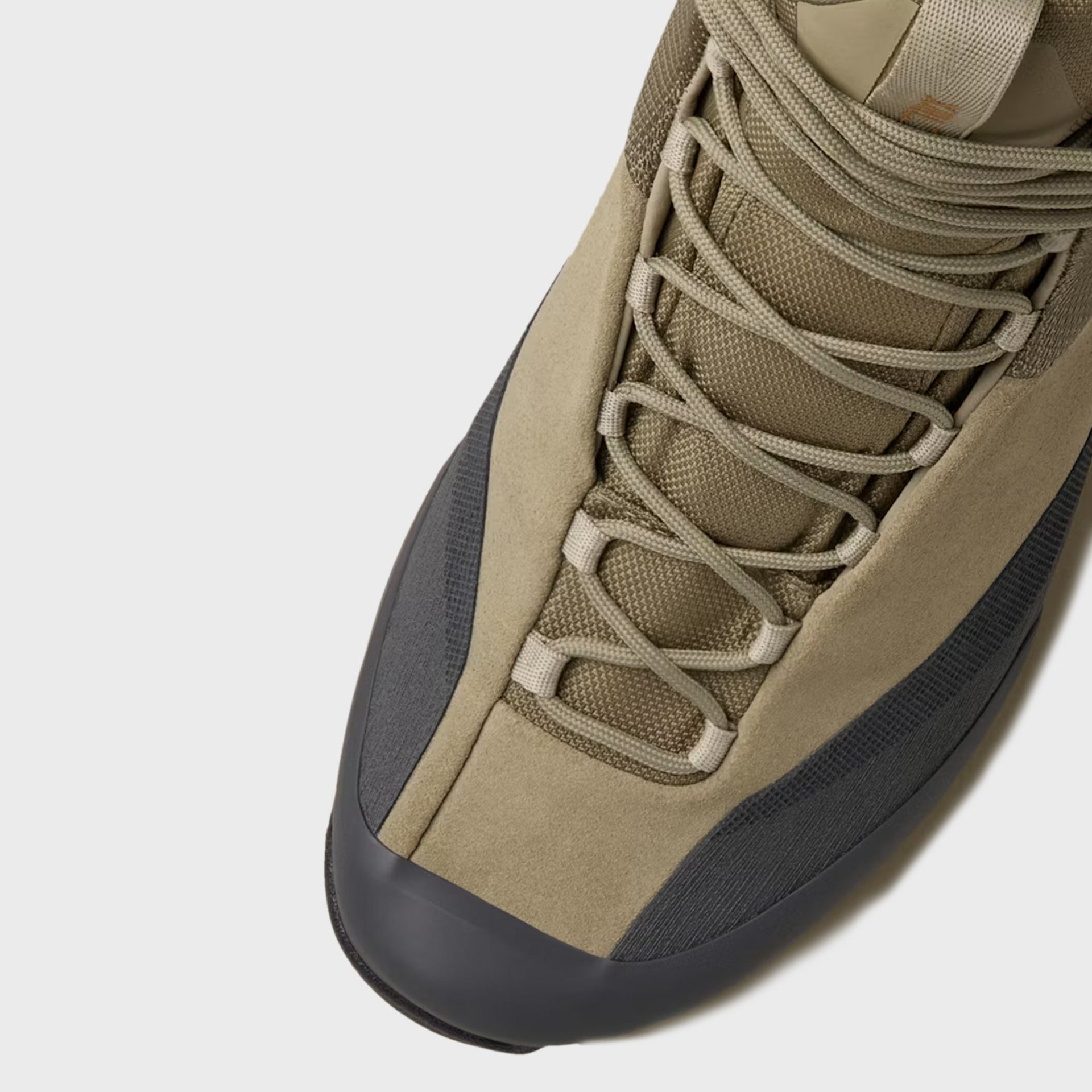 Close-up of Arc'teryx Konseal Trek mid boot in bracken tan showing crossed laces and toe box detail
