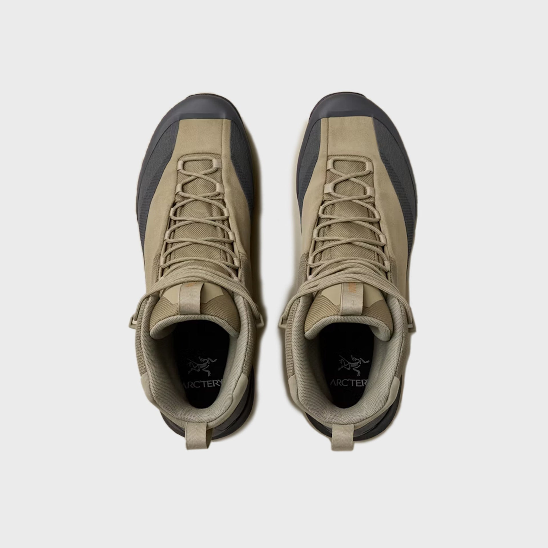 Pair of Arc'teryx Konseal Trek mid boots in bracken tan, top-down view showing Arc'teryx bird logo on black tongue