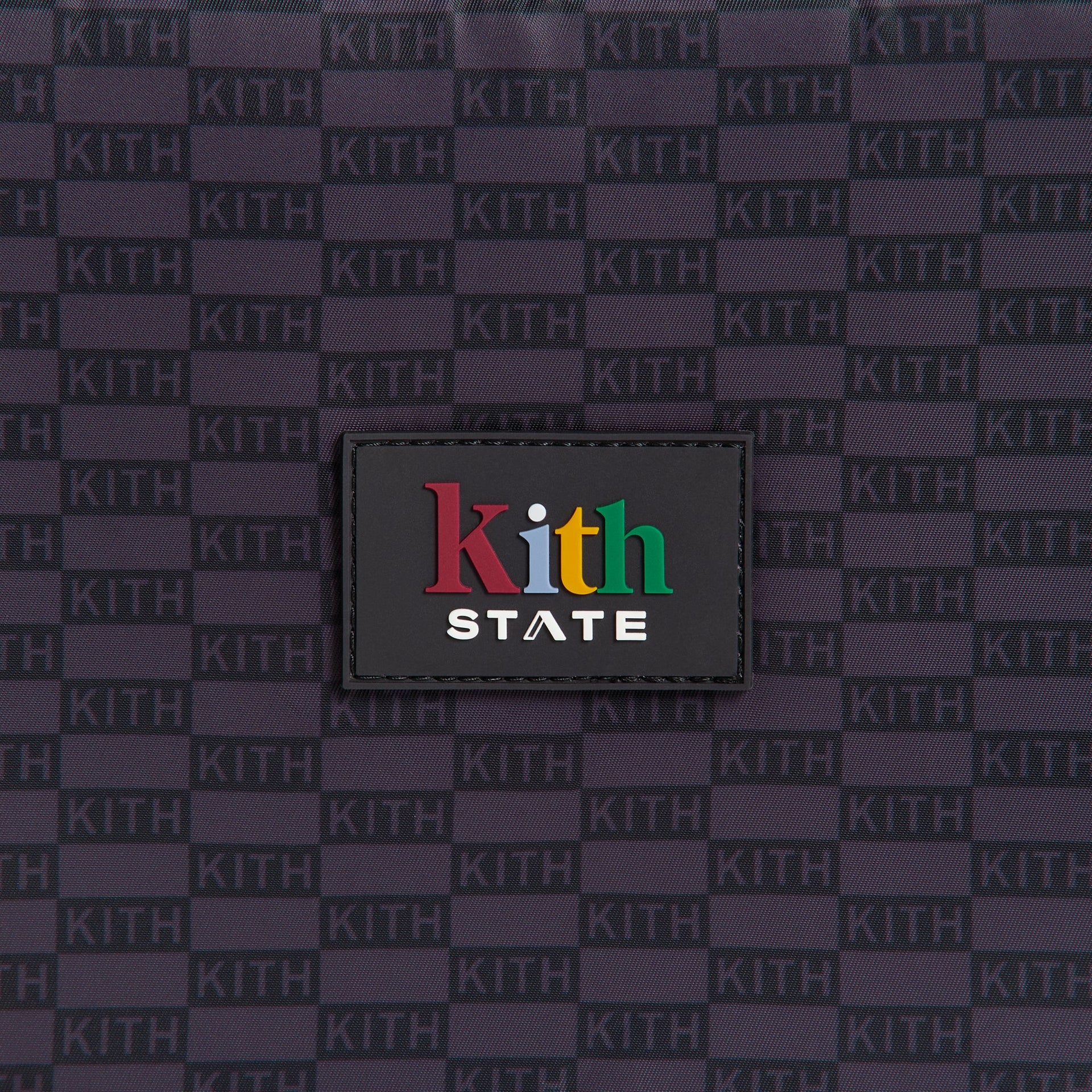 Kith Kids for STATE Rodgers Lunch Box detail of colorful Kith State rubber patch on black checkerboard monogram