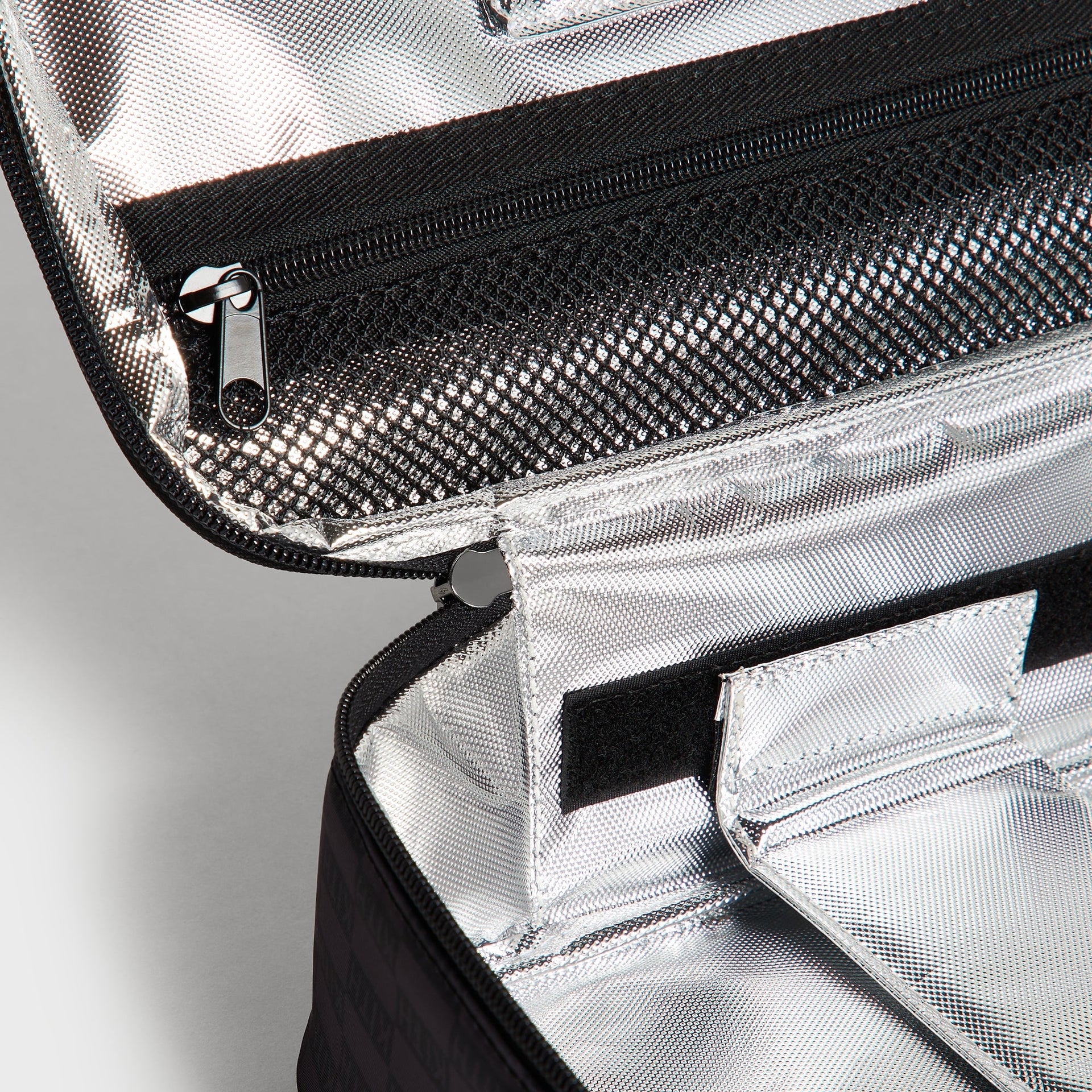Kith Kids for STATE Rodgers Lunch Box open interior showing silver insulated lining and zippered mesh lid pocket