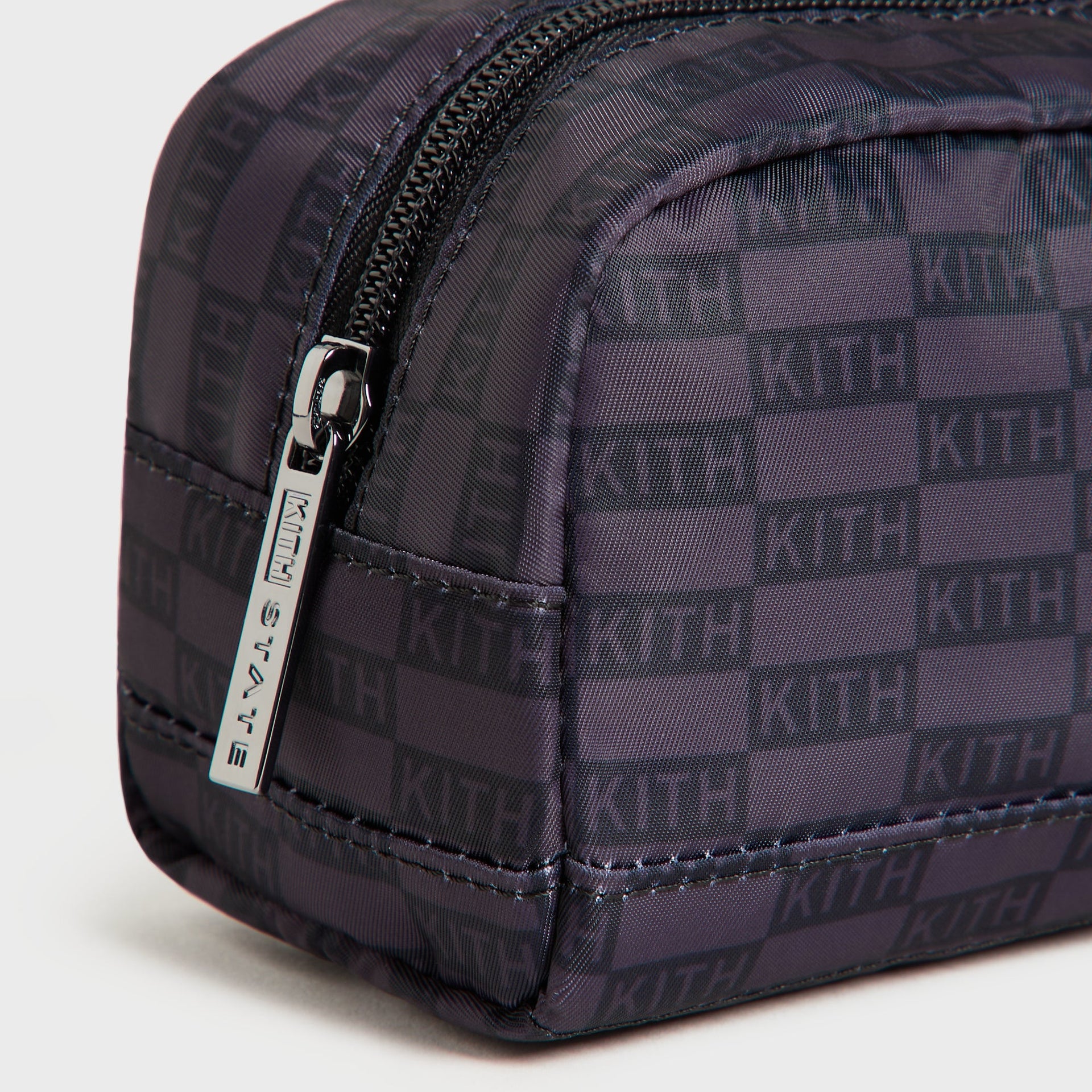 Close-up of Kith STATE branded zipper pull and Black KITH monogram nylon on Clinton Pencil Case