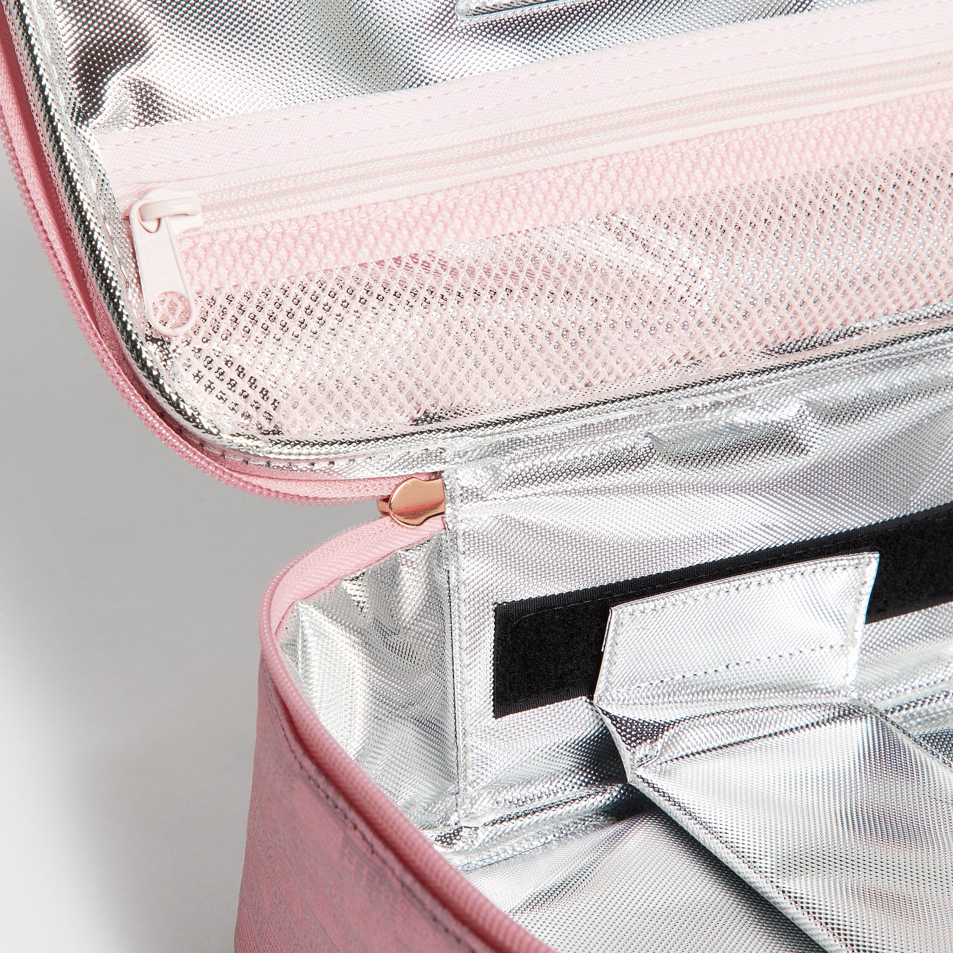 Open interior of Kith Kids for STATE Rodgers Lunch Box showing silver insulated lining and mesh zip pocket