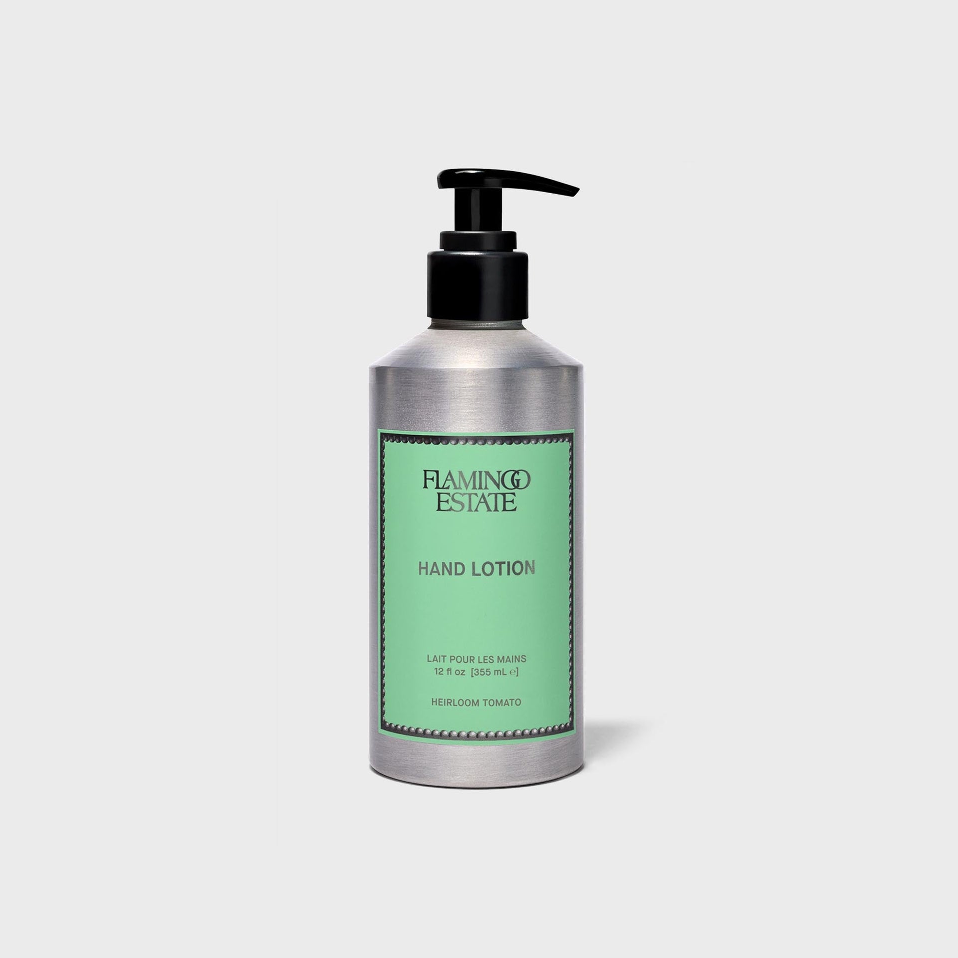 Flamingo Estate Heirloom Tomato hand lotion in brushed aluminum bottle with green label and black pump
