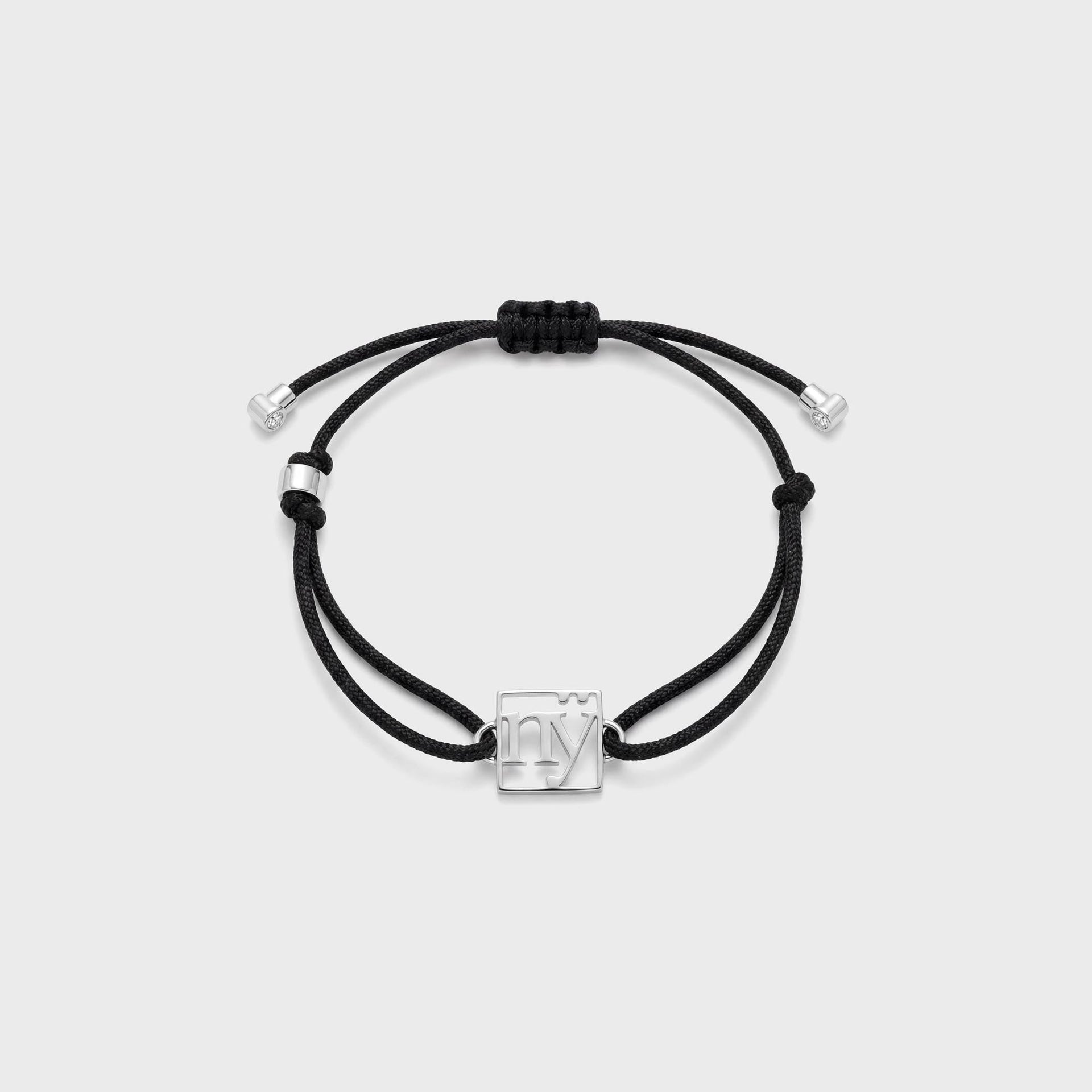 Greg Yuna NY adjustable black cord bracelet with silver cutout 'ny' charm and diamond-tip ends