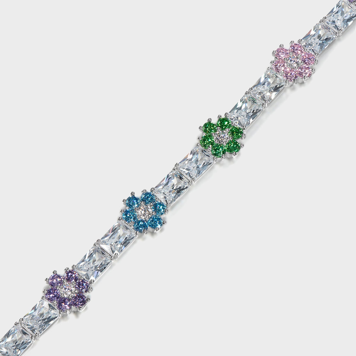 Hatton Labs Bloom Tennis Bracelet in white, close-up of purple, blue, green and pink flower clusters between baguette stones