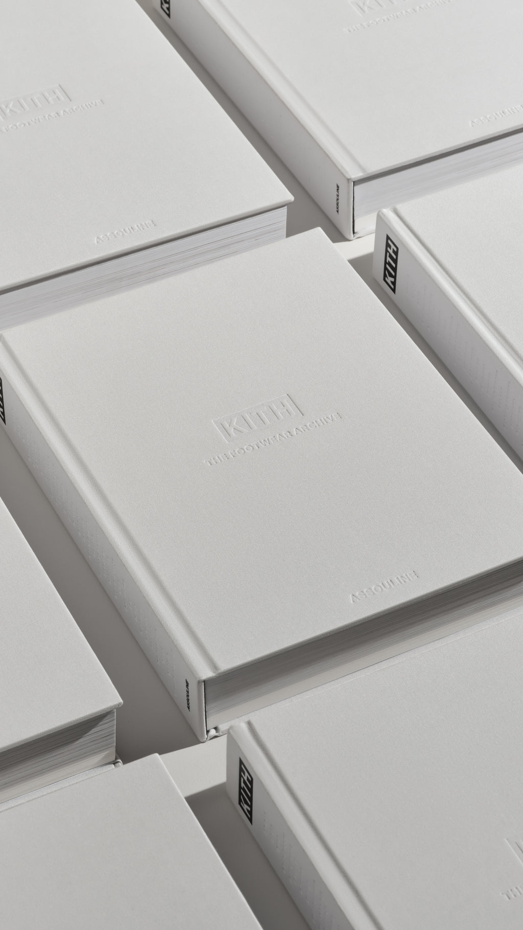 Overhead mobile view of stacked Kith: The Footwear Archive books by Assouline