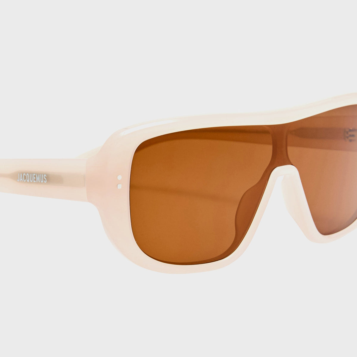 Jacquemus JAC156C2SUN aviator sunglasses in white with amber lenses, close-up angled front view