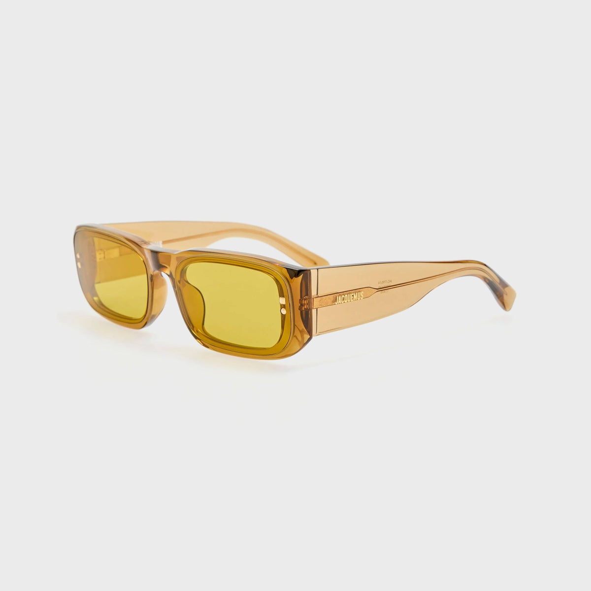 Jacquemus Pisco sunglasses in translucent amber with yellow lenses, three-quarter angled view