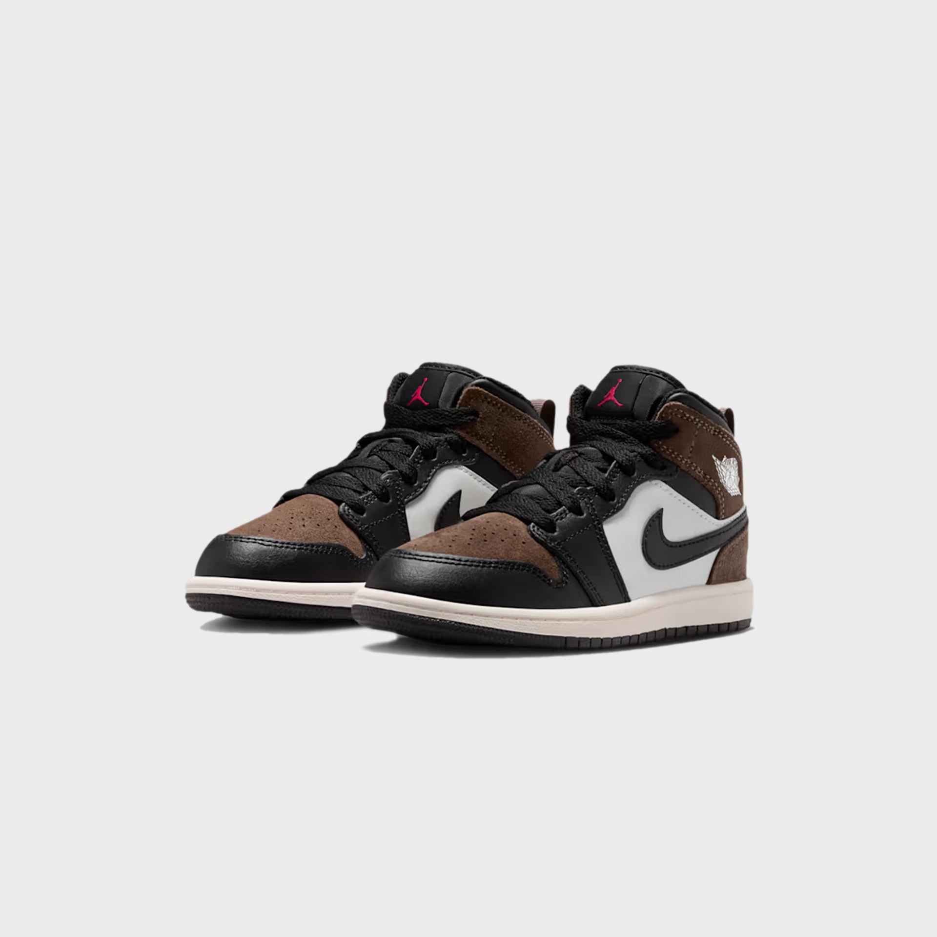 PS Air Jordan 1 Mid pair, front three-quarter view with red Jumpman tongue tags and Palomino suede toes