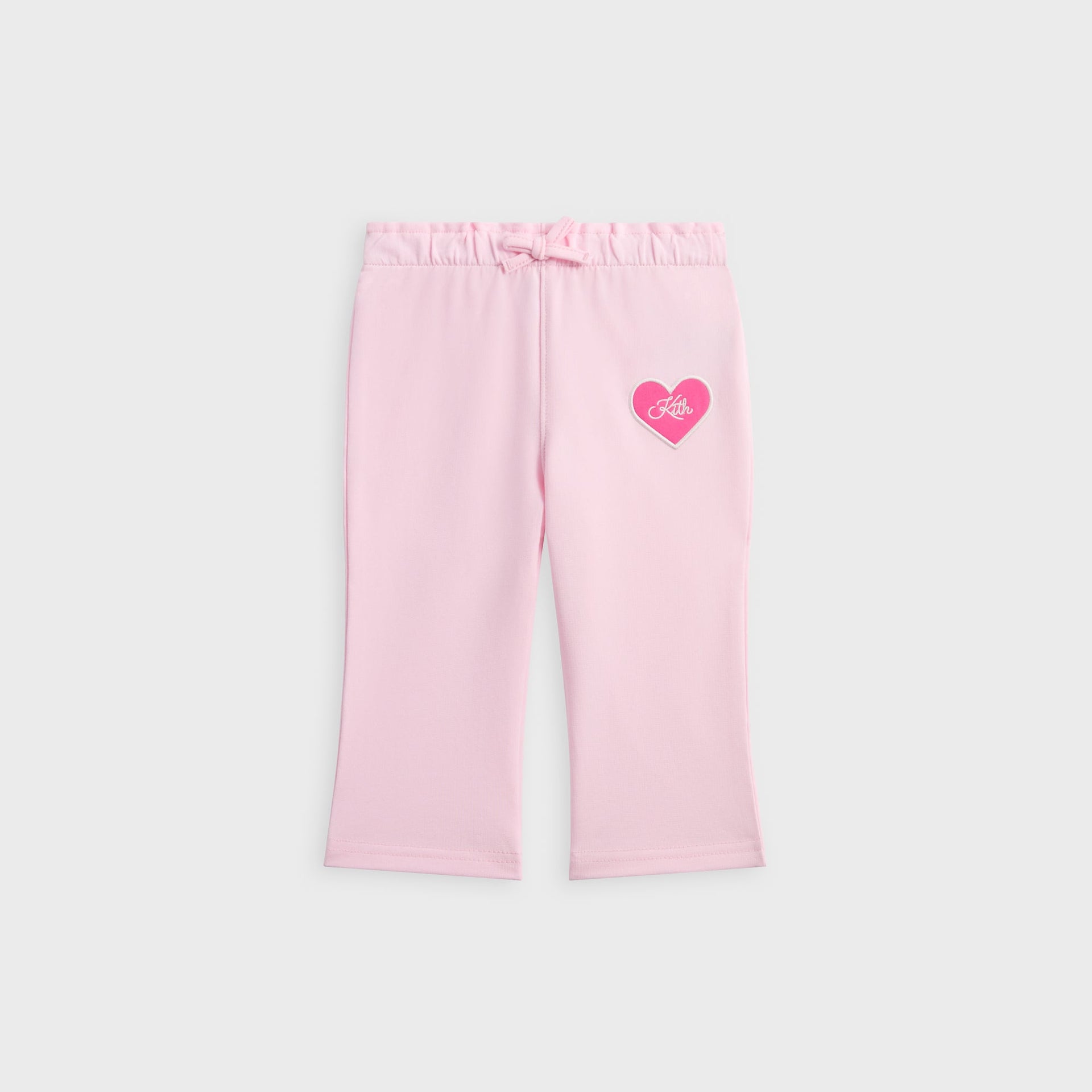 Kith Baby Alani Sweatpant in pink, front flat lay with drawstring waist and pink heart Kith patch