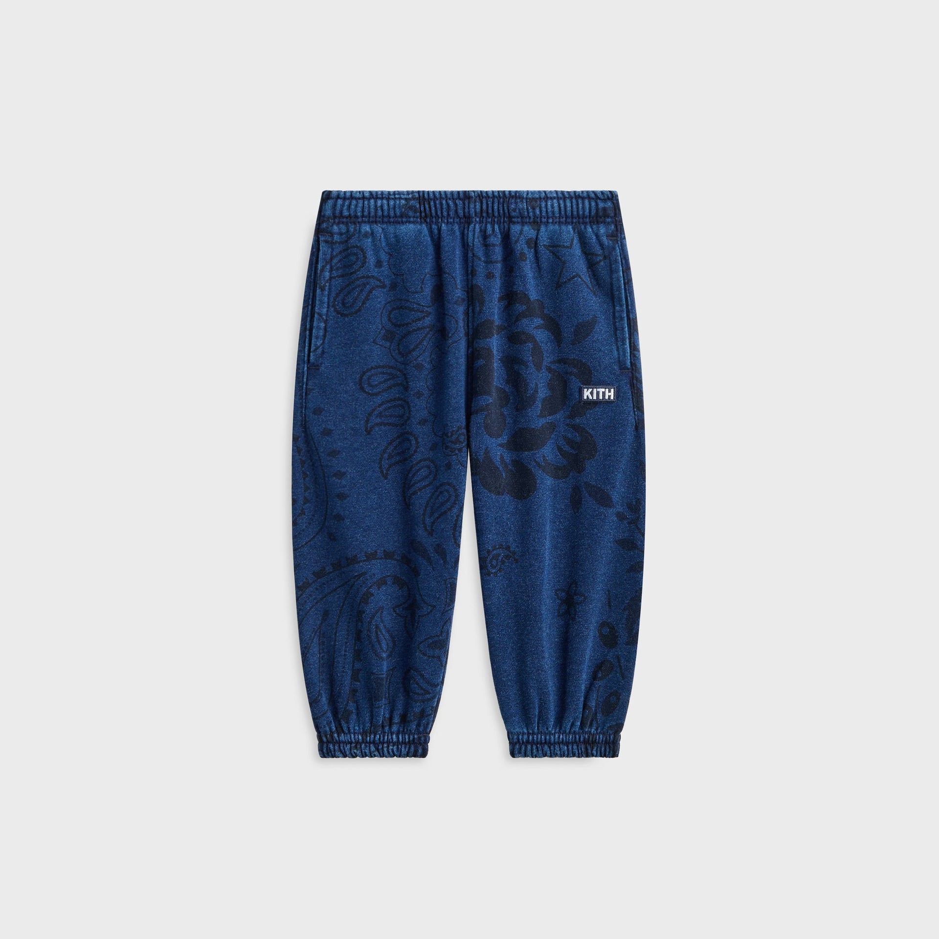 Kith Baby Paisley Nelson Sweatpant in Dark Indigo, front flat lay with black bandana paisley print and KITH woven label