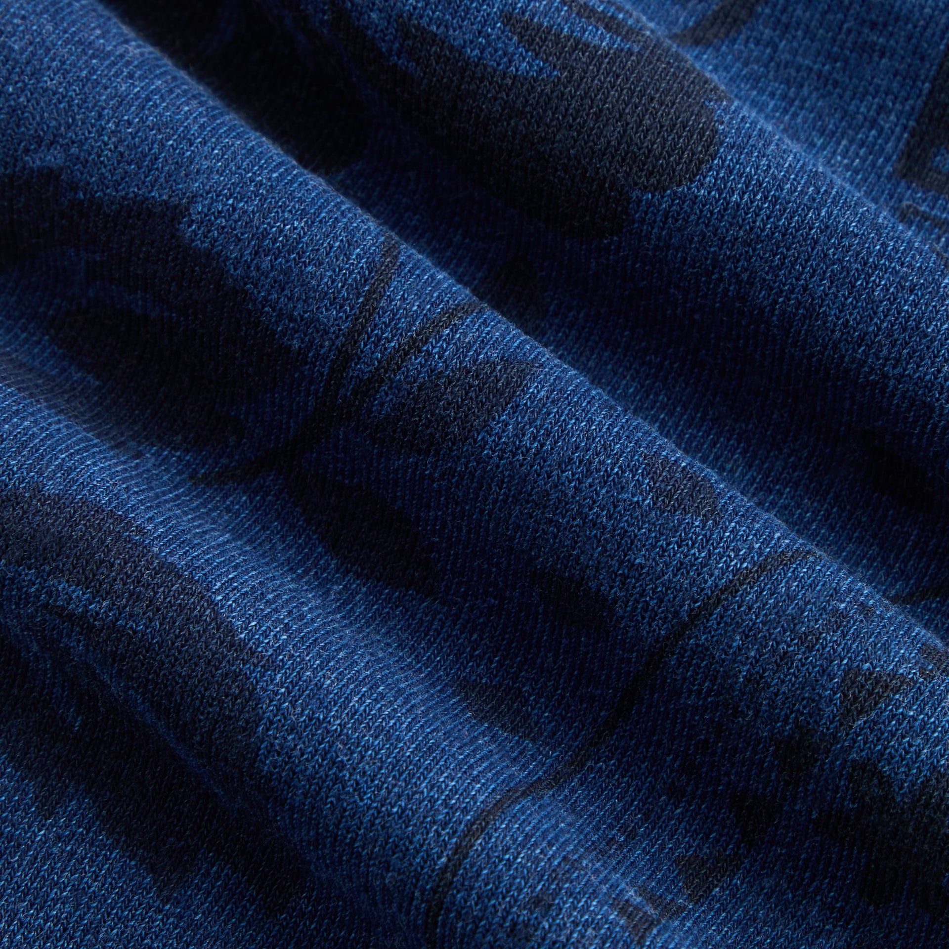Kith Baby Paisley Nelson Sweatpant in Dark Indigo, macro detail of heathered indigo knit fabric and print