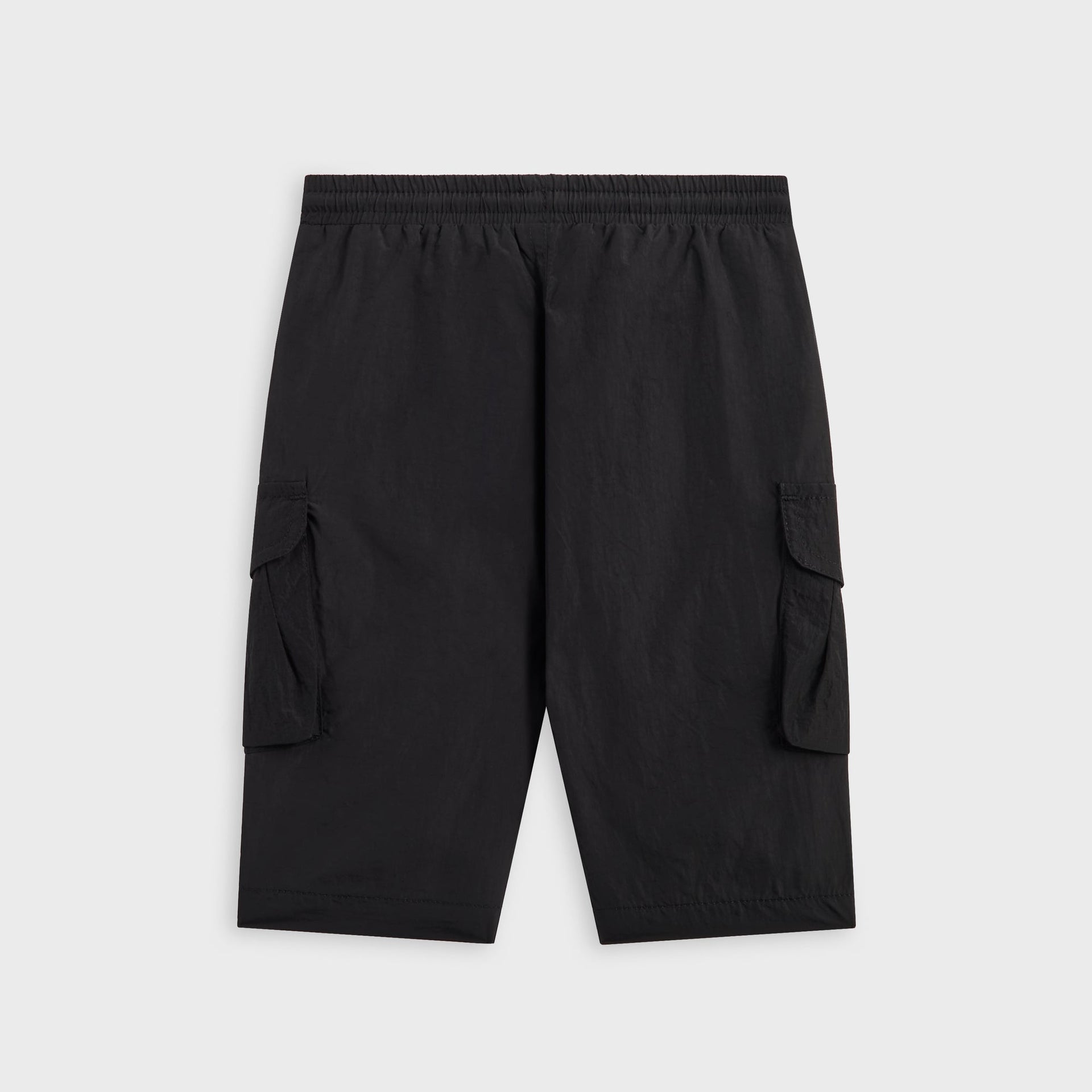 Kith Baby Parachute Pant in black, back view of nylon cargo shorts with elastic waist and side flap pockets