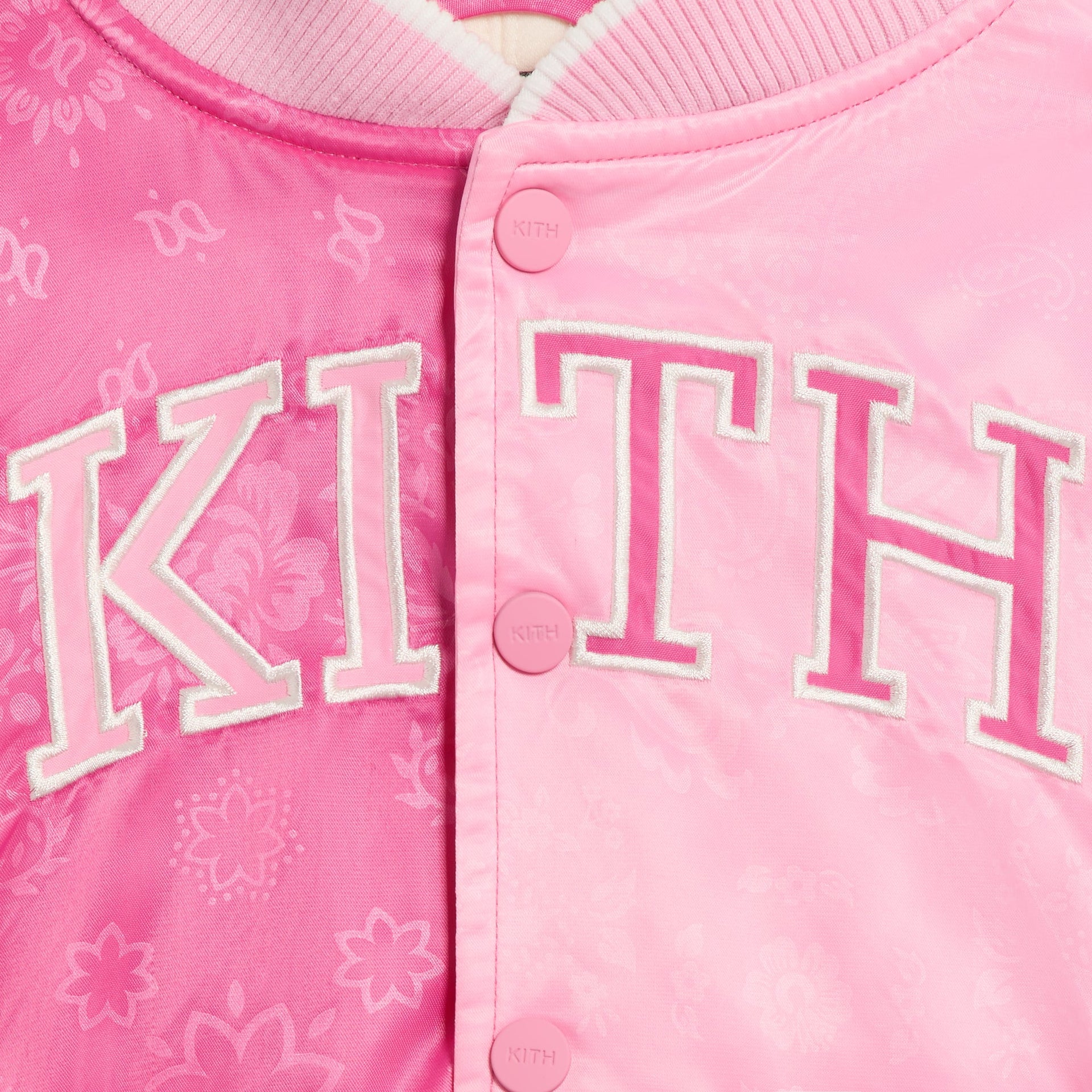 Kith Kids Gorman Jacket in Canna pink paisley, close-up of KITH varsity applique and snap buttons