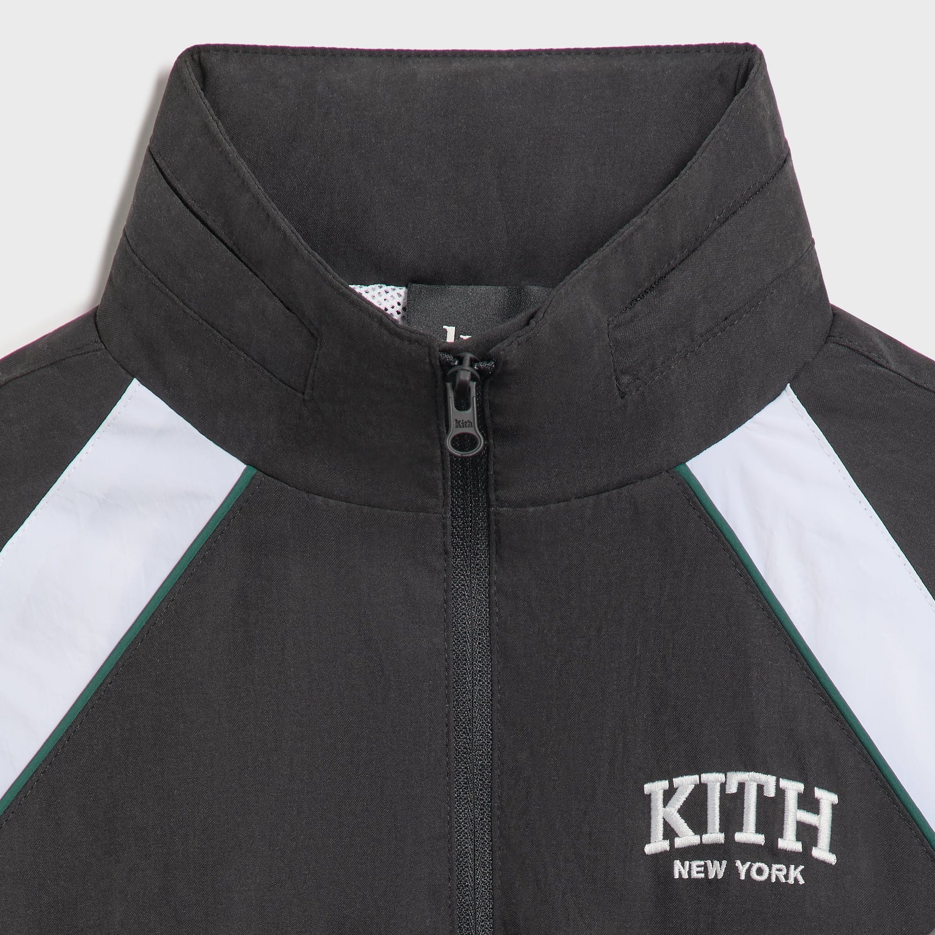 Kith Kids Linden Track Jacket, close-up of black stand collar, zipper and white Kith New York embroidery