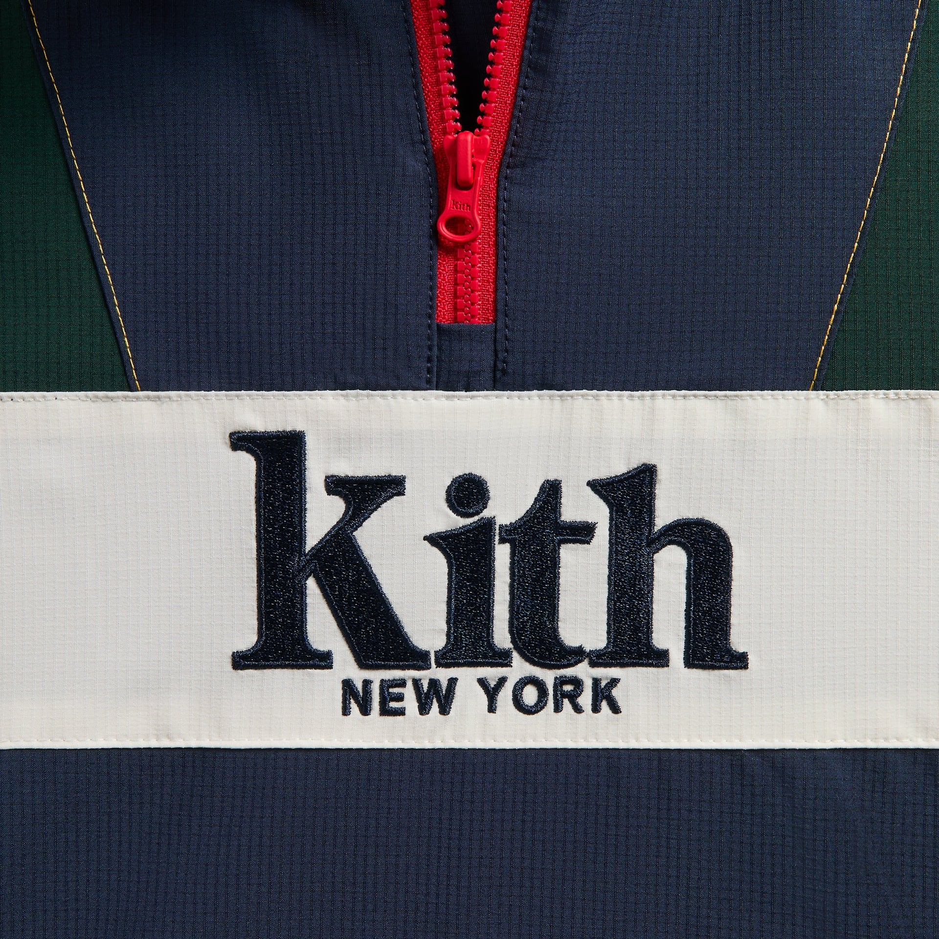 Kith Kids Harrison Track Pullover, close-up of Kith New York embroidered logo and red half-zip