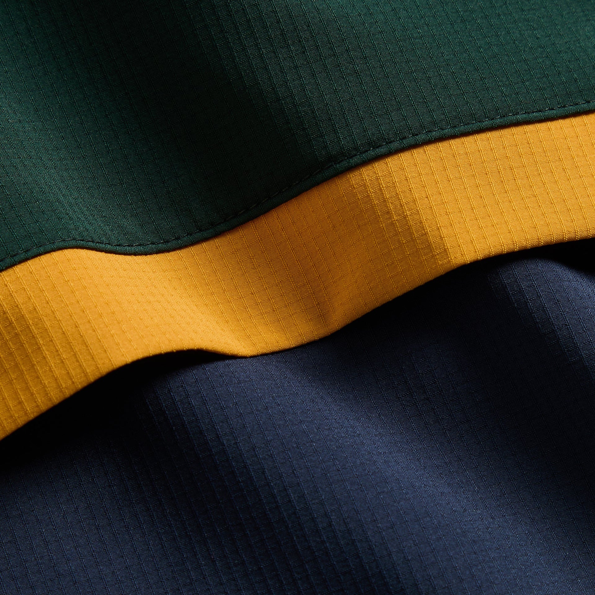Kith Kids Harrison Track Pullover, macro close-up of green, gold and navy ripstop panels
