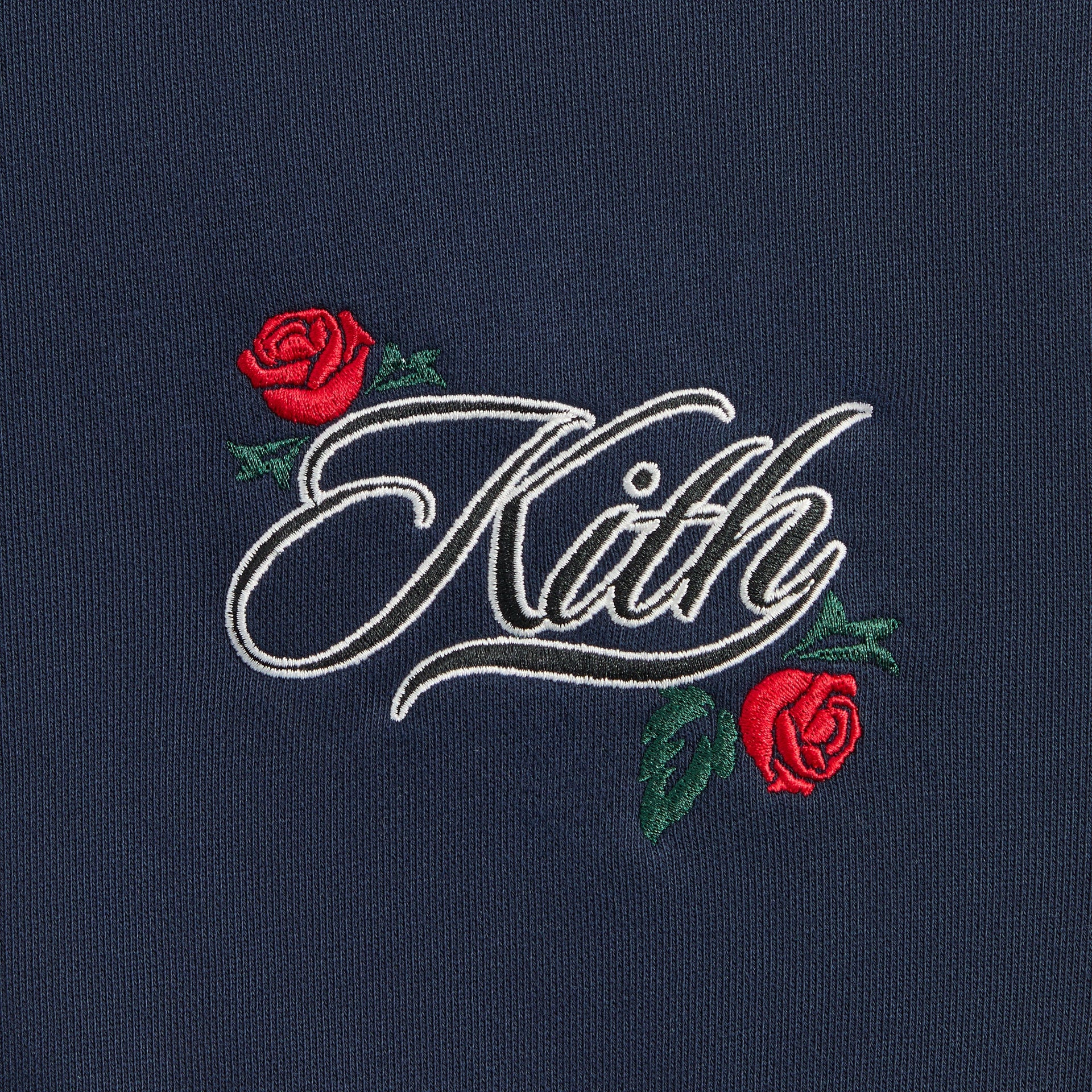 Kith Kids Wyona Bomber Jacket in Nocturnal navy, close-up of Kith script chest embroidery with red roses