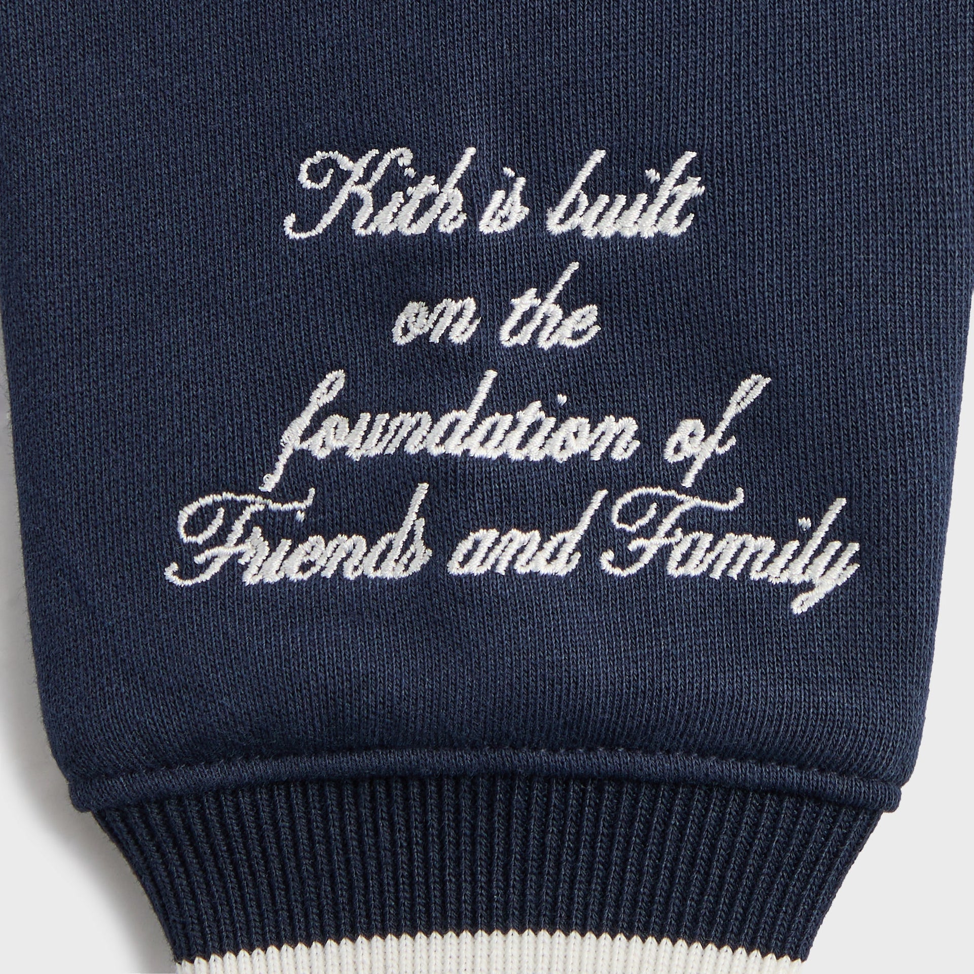 Kith Kids Wyona Bomber Jacket in Nocturnal navy, close-up of embroidered Friends and Family sleeve text