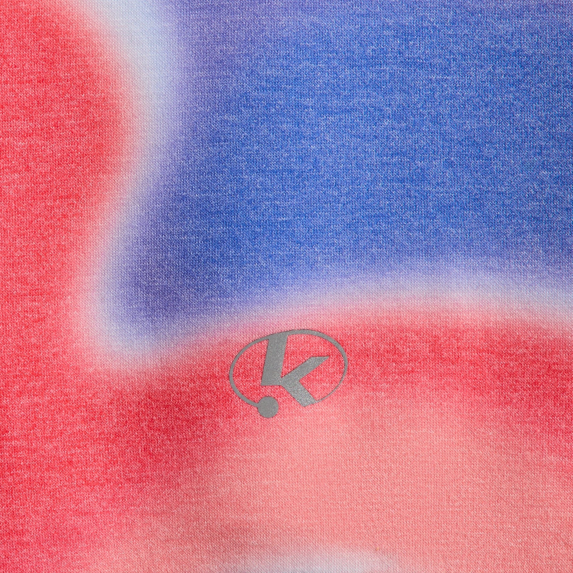 Close-up of K oval logo on red and blue Tempo swirl print Kith Kids Adinah Quarter Zip hoodie