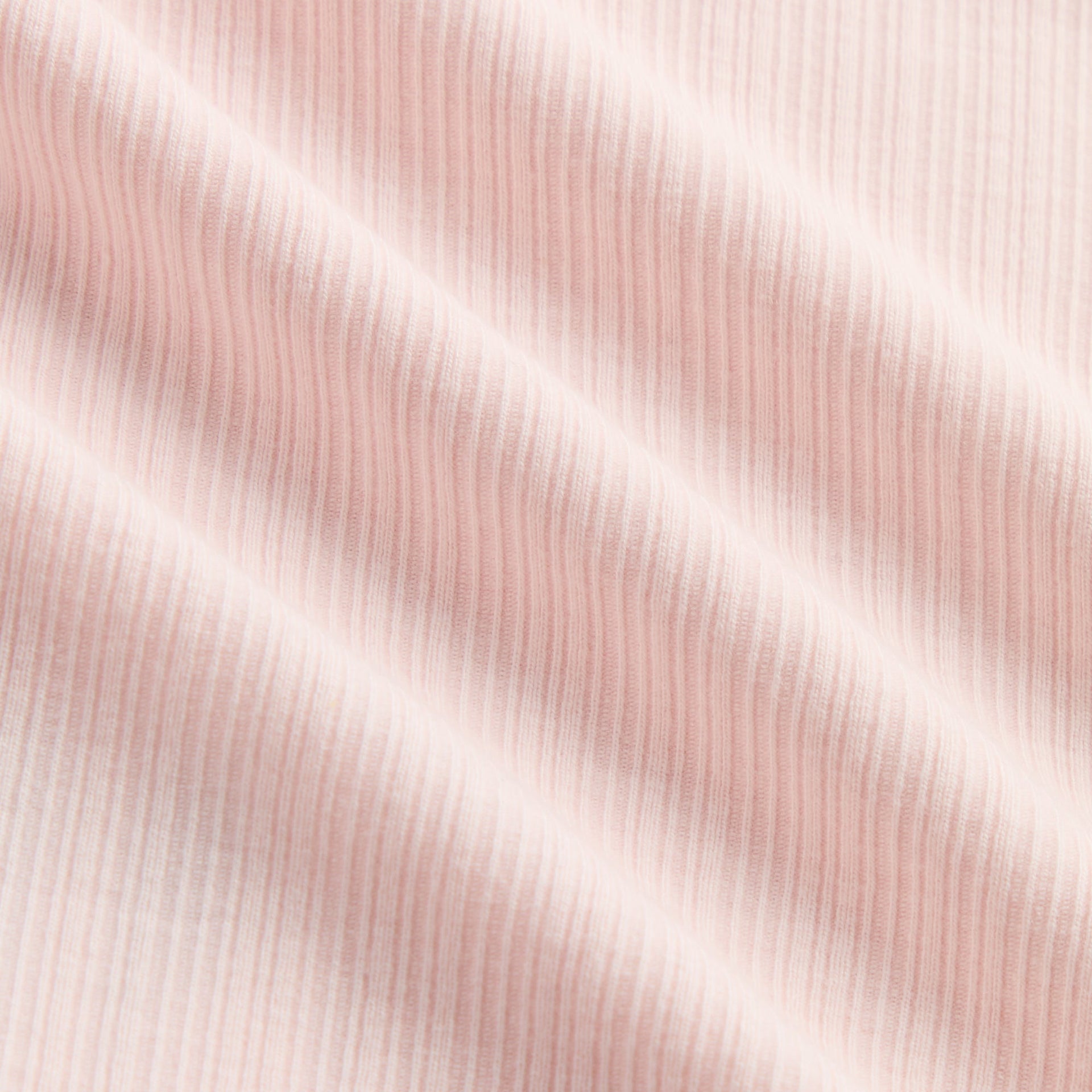 Kith Kids Mulberry Turtleneck in Bloom, macro close-up of pale pink ribbed fabric