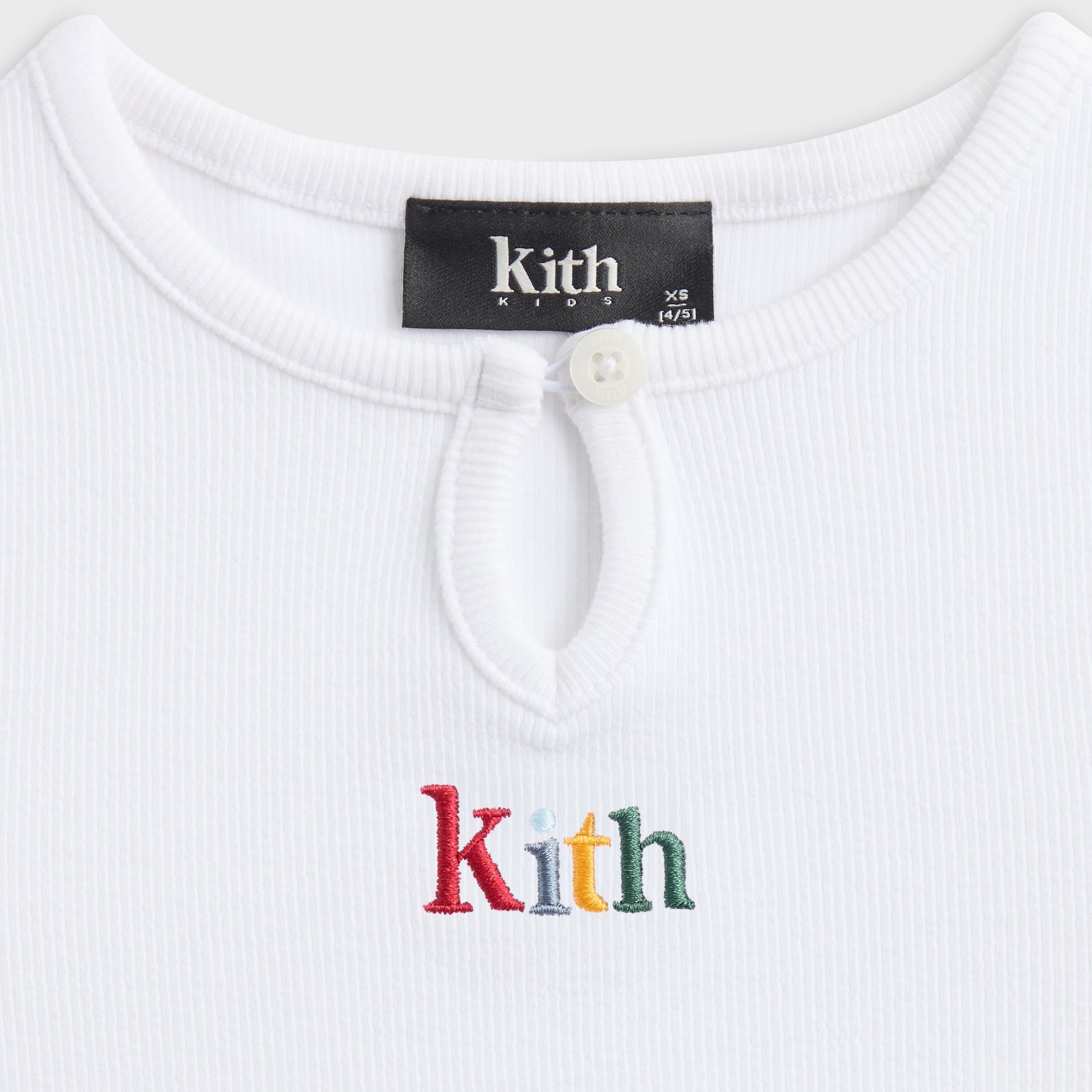 Close-up of the ribbed keyhole button neckline and multicolor Kith embroidery on the white Mulberry III tee