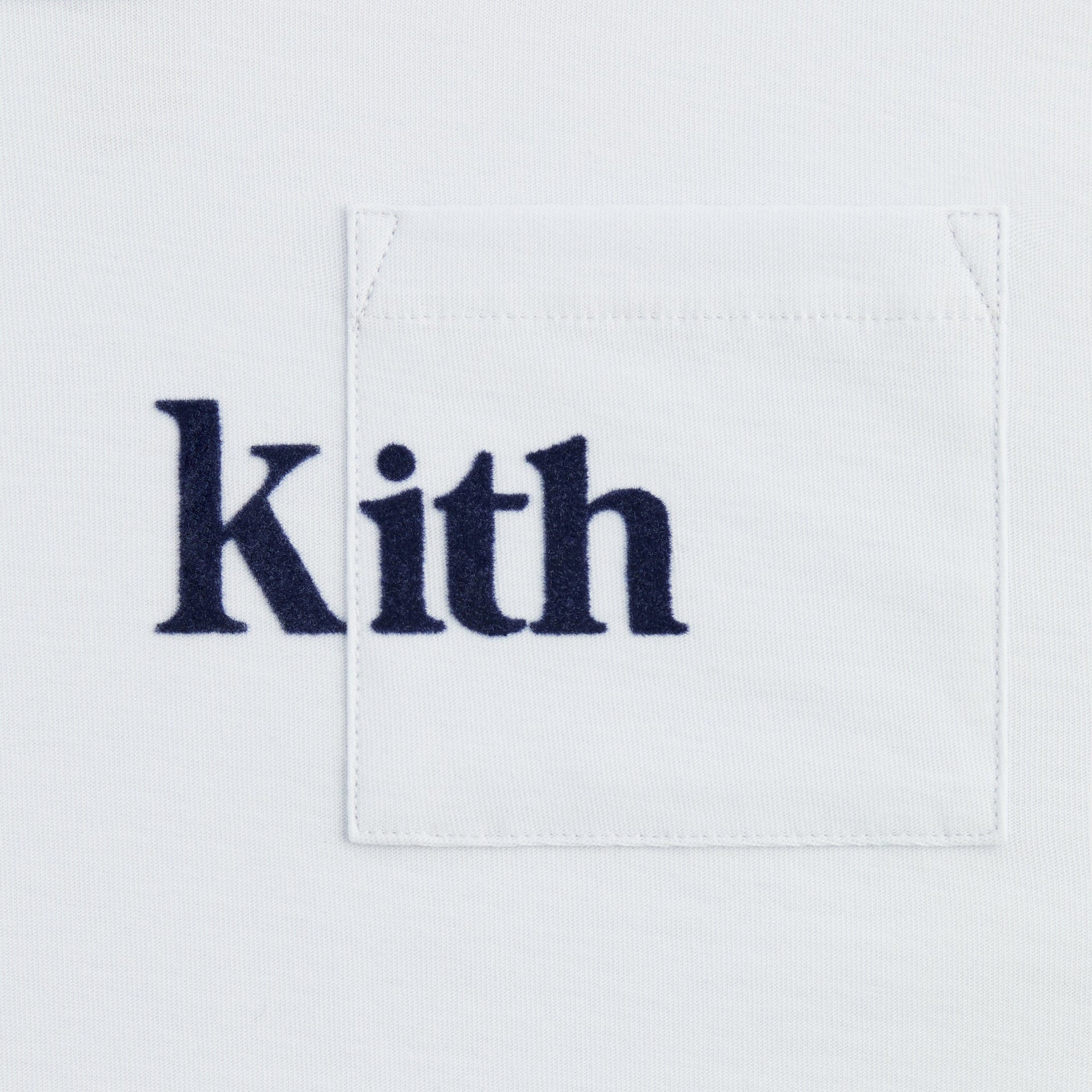 Kith Kids Quinn II Tee, close-up of navy Kith logo on chest pocket of pale blue tee