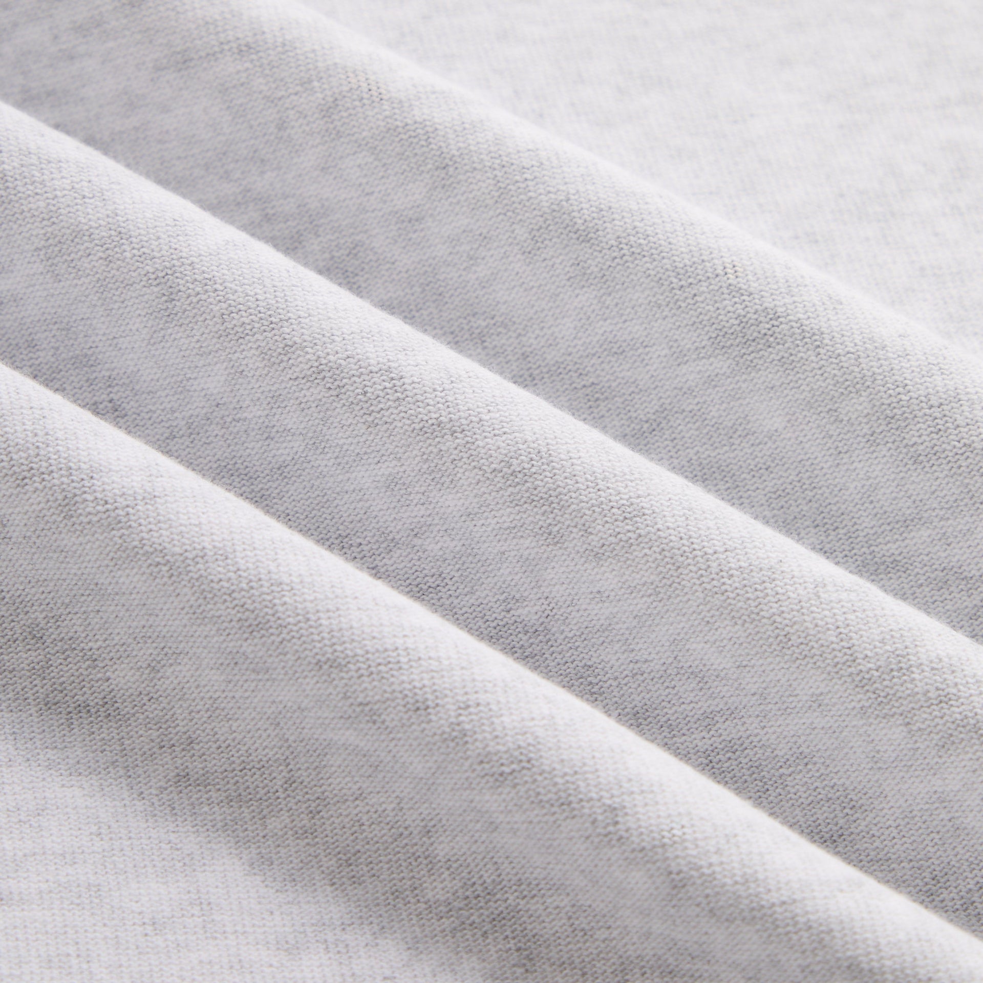 Close-up of soft light heather grey cotton jersey fabric on Kith Kids LAX Tee