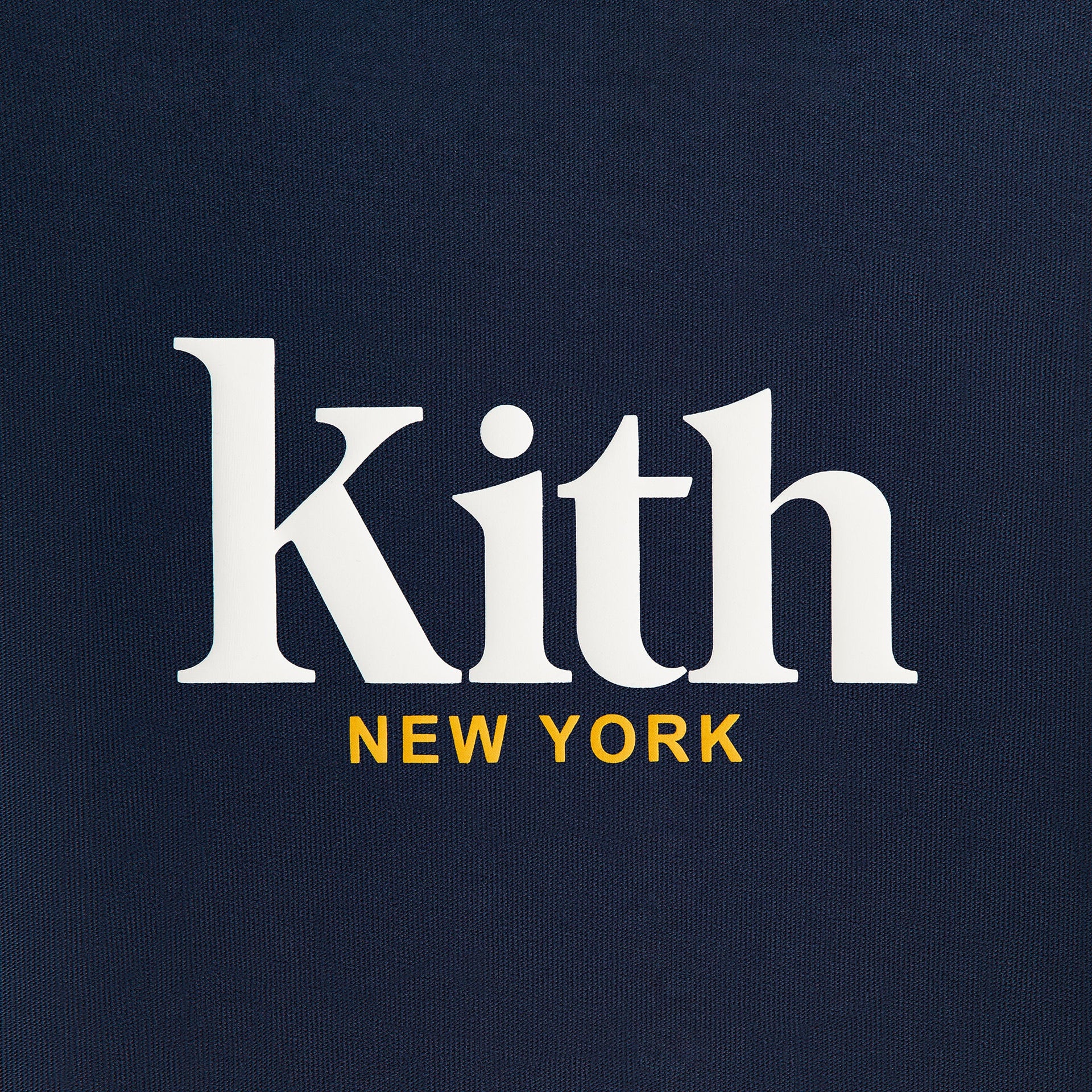 Kith Kids Classic Mott Tee close-up of white Kith serif logo and yellow New York text on navy