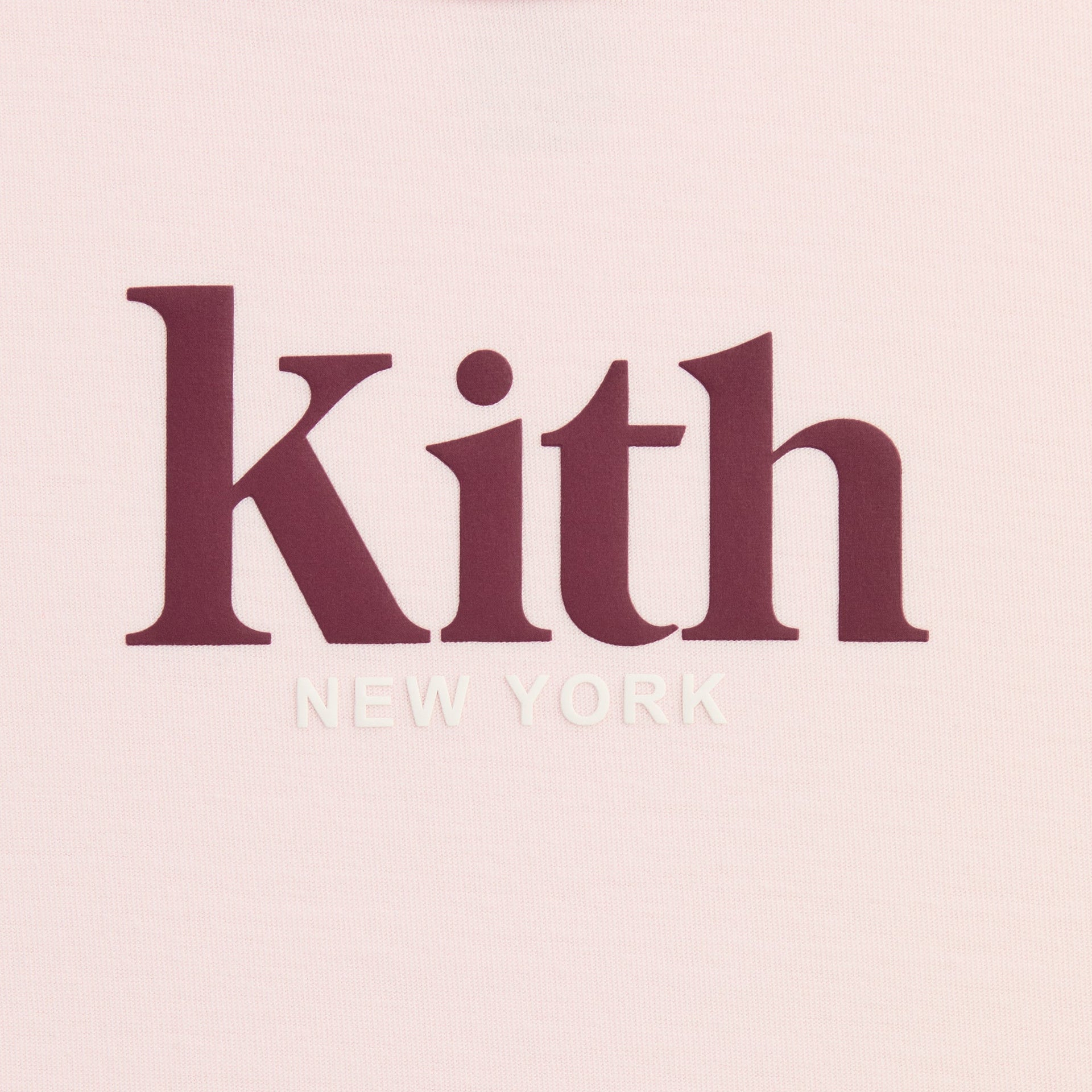 Close-up of burgundy and white Kith New York logo print on Bloom pink Mott Tee