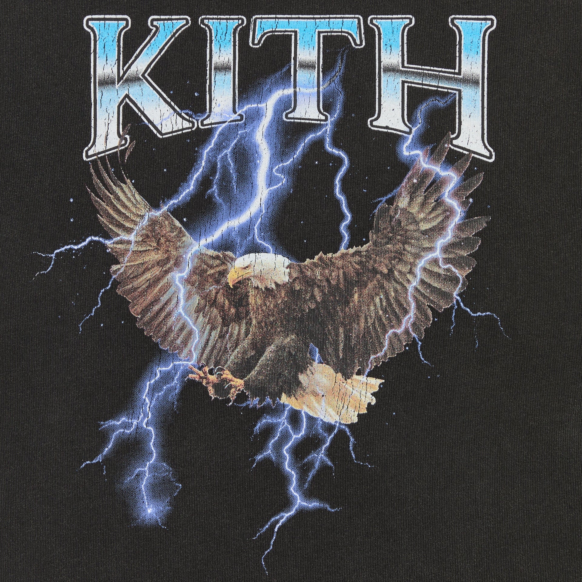 Close-up of bald eagle, blue lightning and chrome KITH graphic print on Black Kith Kids Vintage Eagle Tee