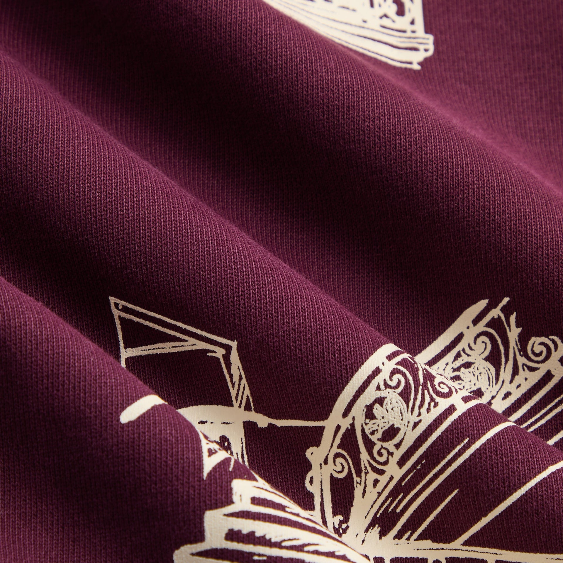 Kith Kids Hunter Pullover macro of burgundy fleece fabric with cream sketch print detail
