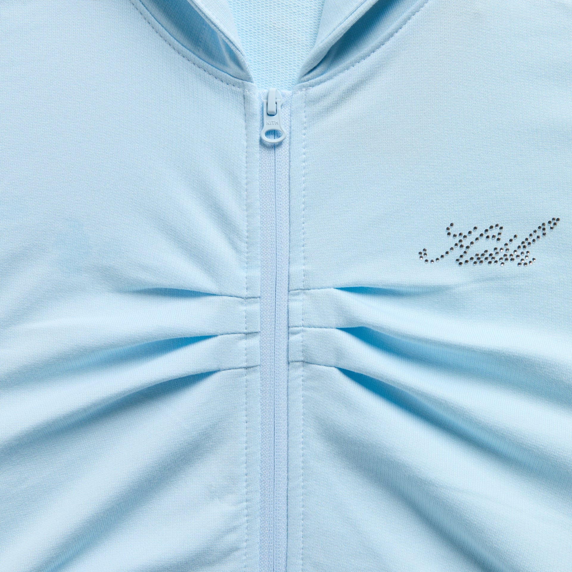 Kith Kids Cropped Nelson Hoodie close-up of zip pull, ruched front and rhinestone Kith logo