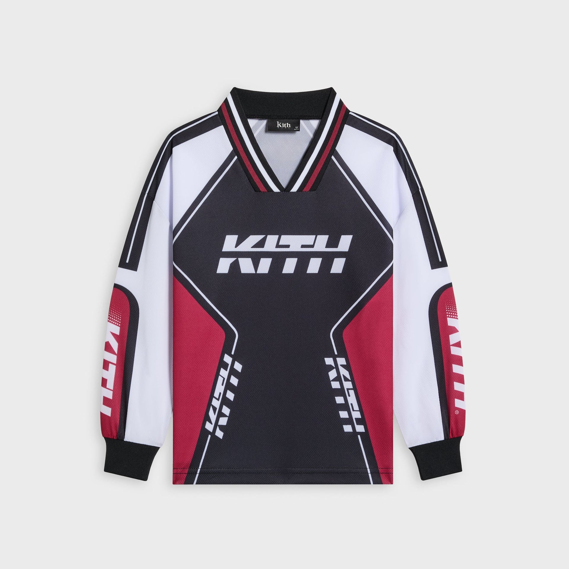 Kith Kids Moto Mesh Donovan jersey tee in black, front flat lay with white and red racing panels and white KITH logo across the chest