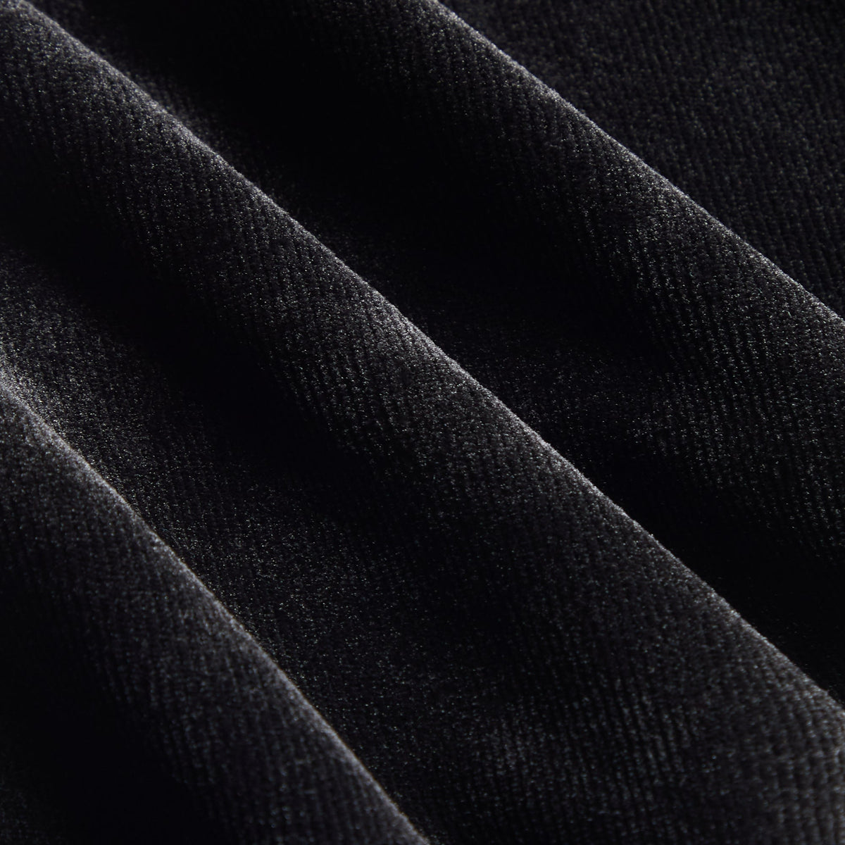 Close-up of the black velour textured fabric of the Kith Kids V-Neck Nelson sweatshirt