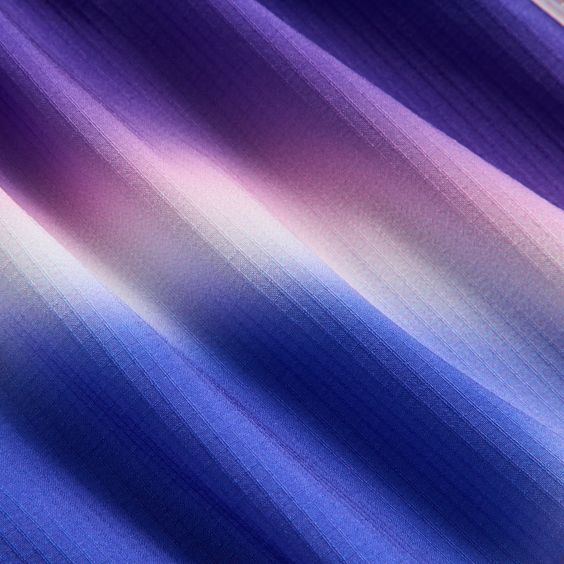 Kith Kids Printed Jazmyn II Active Short, close-up of blurred purple, pink and blue gradient ripstop fabric