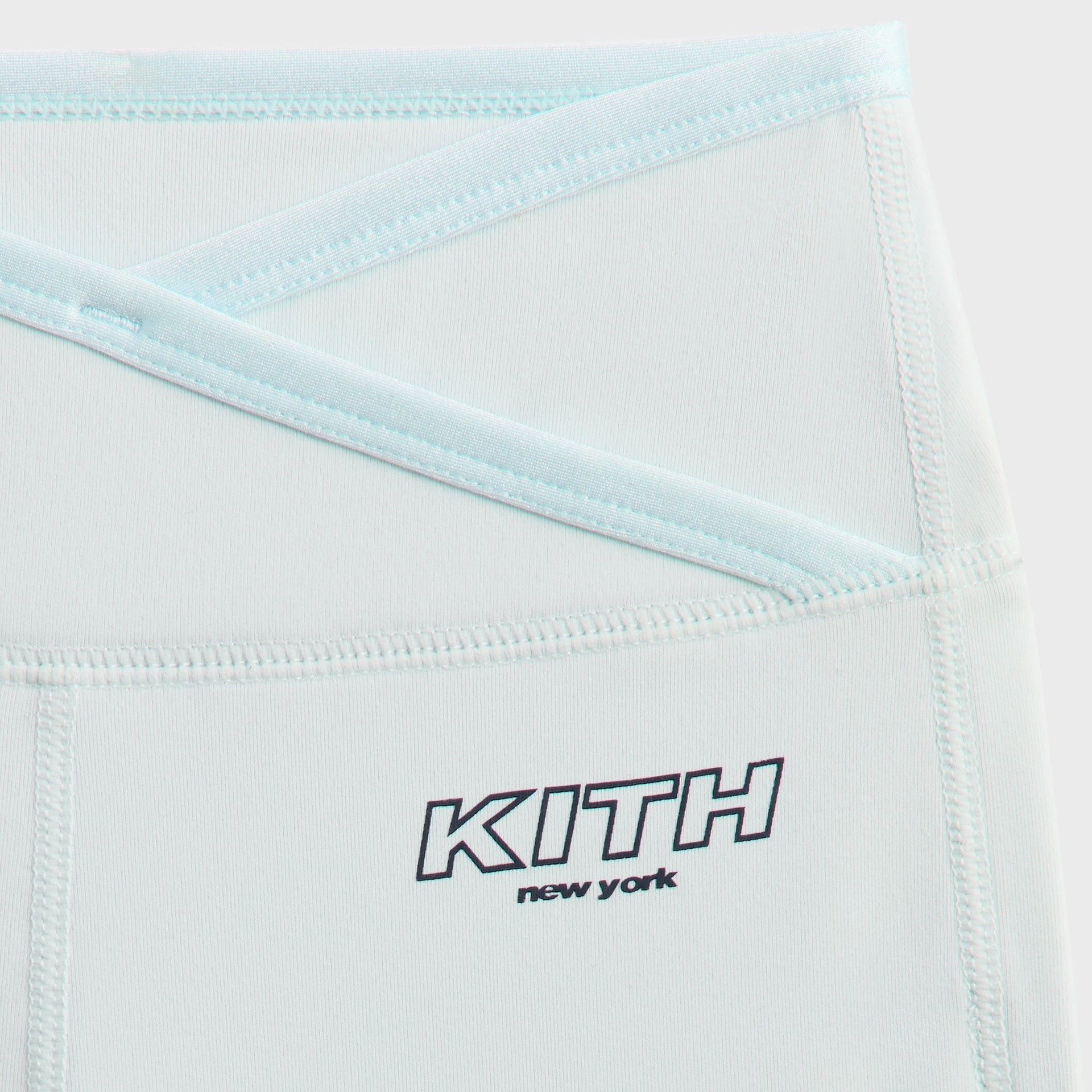 Kith Kids Active Jasina Flare Legging, close-up of crossover front waistband and KITH New York logo