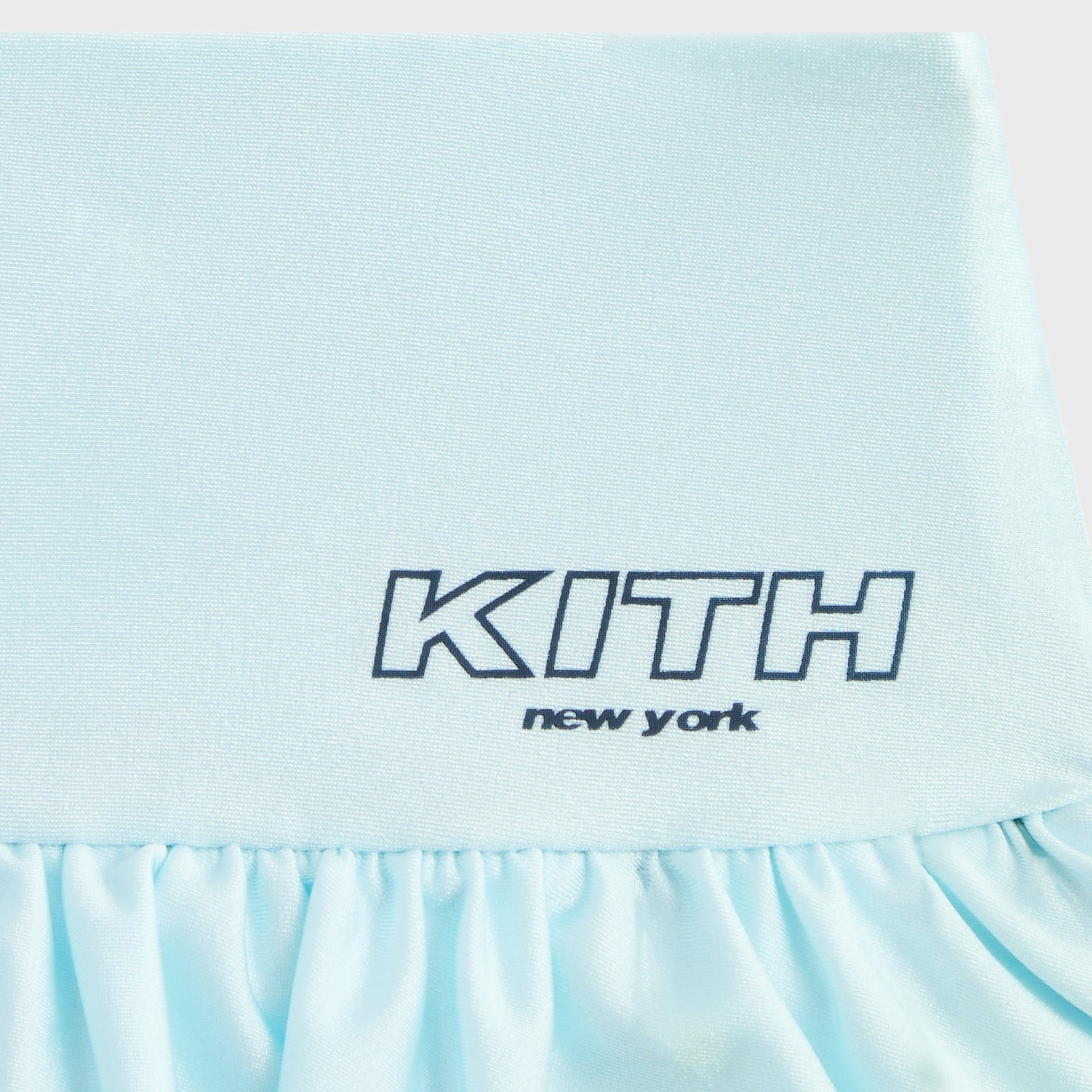 Kith Kids Active Savina Tiered Skort in light blue Surry, close-up of KITH New York logo on satin waistband