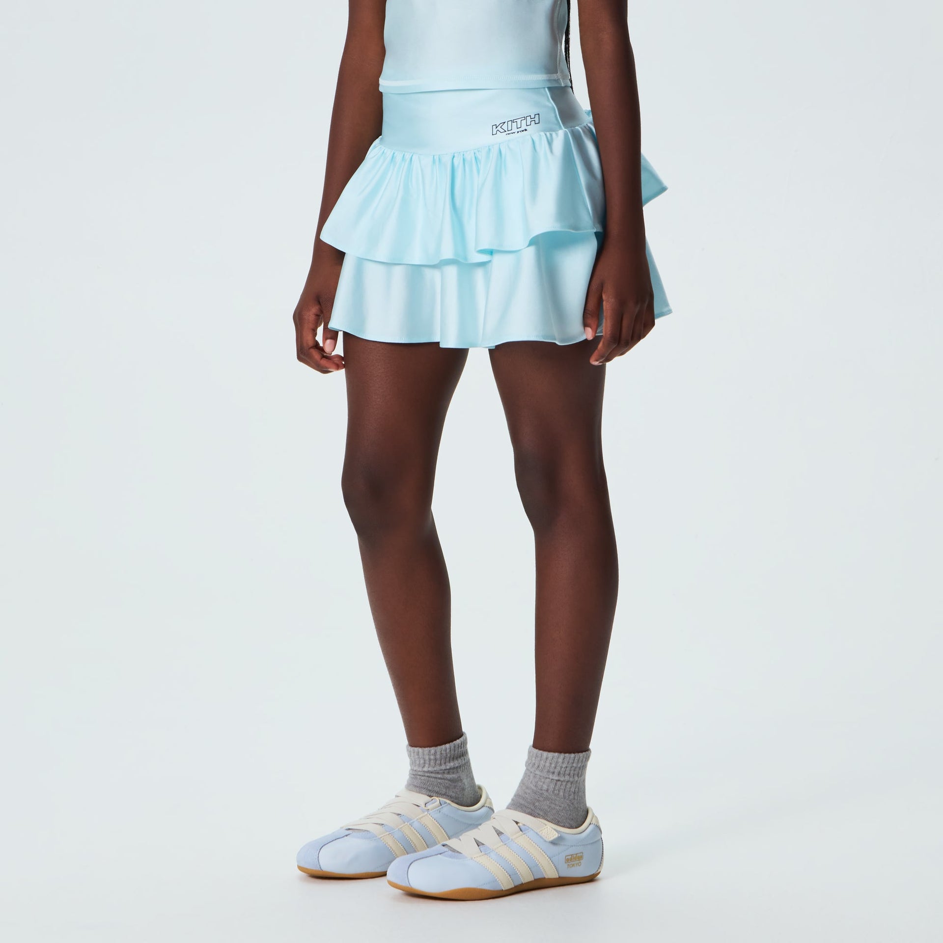 Kith Kids Active Savina Tiered Skort in light blue Surry, worn on model, front view styled with sneakers