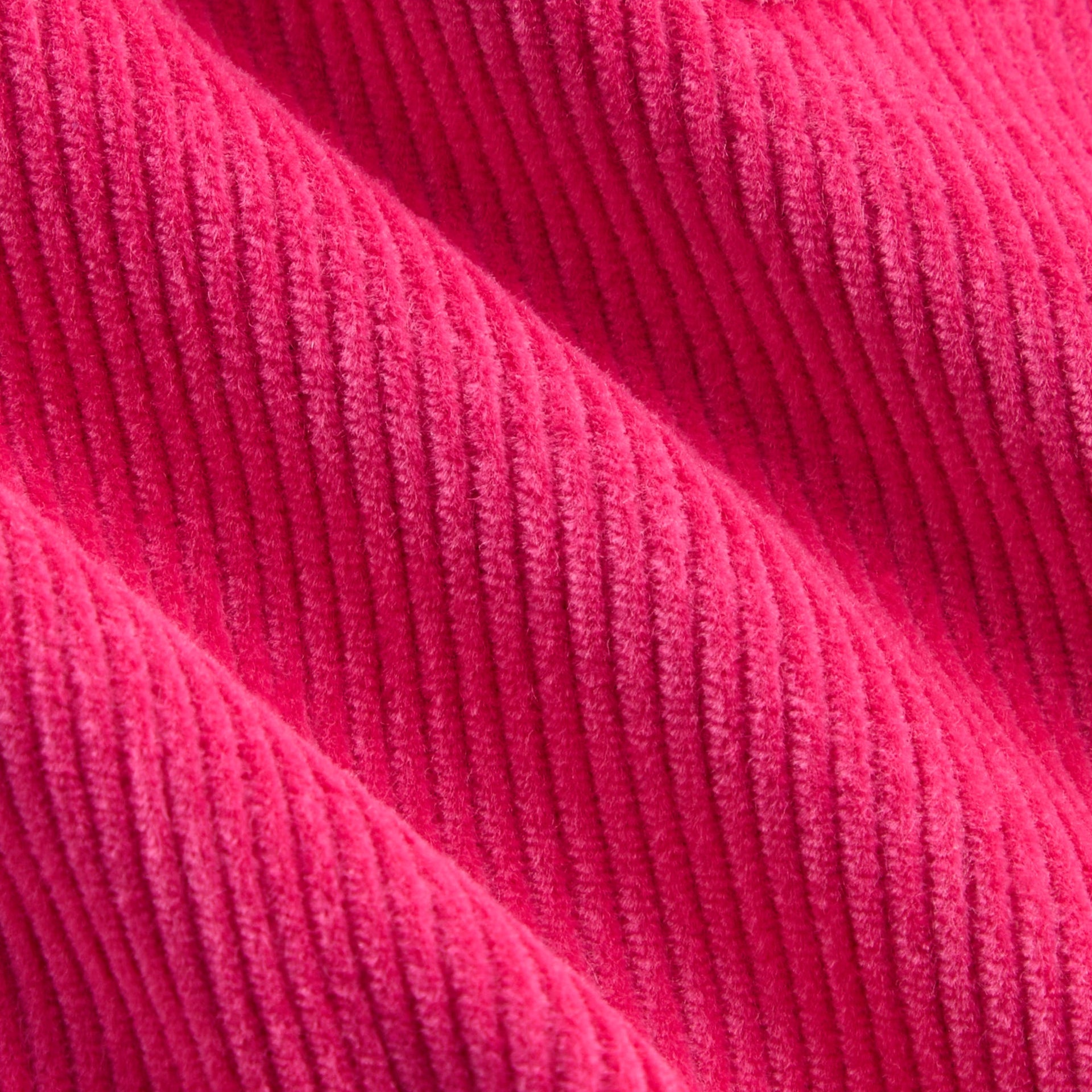 Close-up of hot pink Zinnia wide-wale corduroy fabric texture of Kith Kids Jessie Cord Skirt