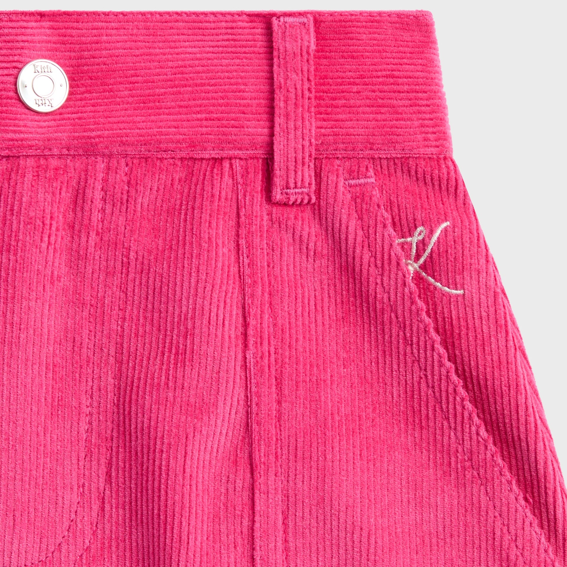 Close-up of pink Zinnia corduroy waistband with Kith silver shank button and belt loop on Jessie Cord Skirt