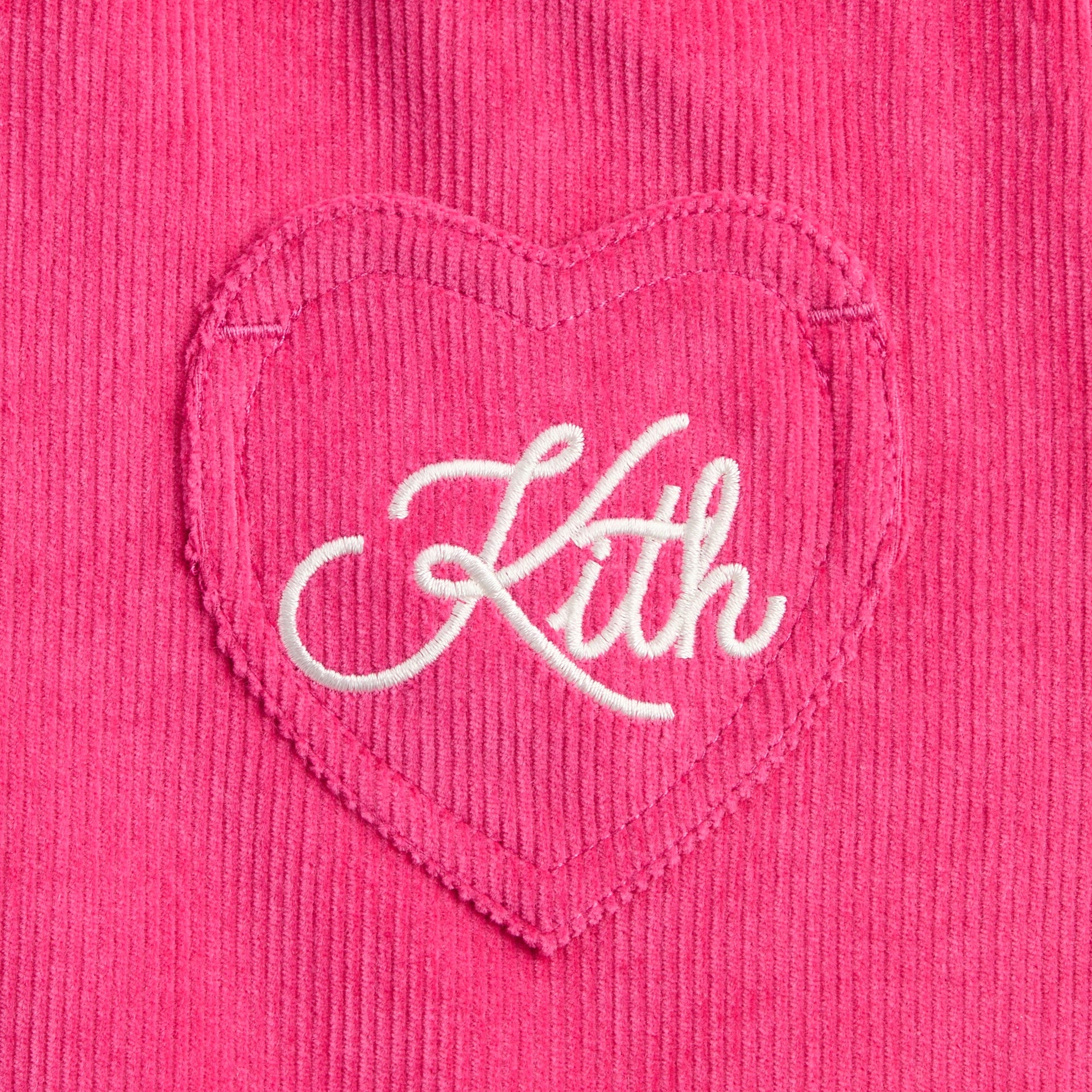 Close-up of heart-shaped pocket with white cursive Kith embroidery on pink Zinnia Jessie Cord Skirt