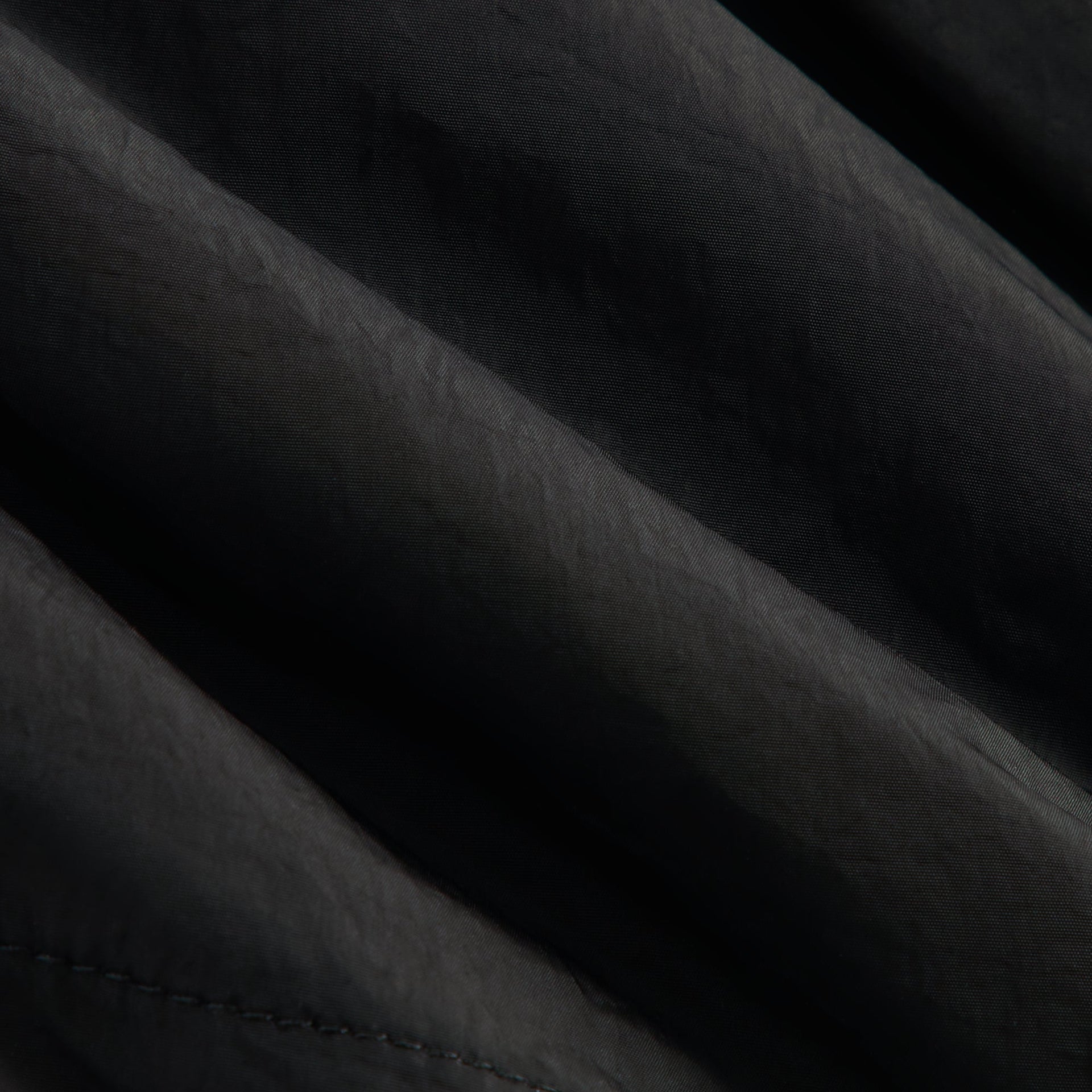 Kith Kids Kaiden Pant in Black, macro detail of crinkled black nylon fabric