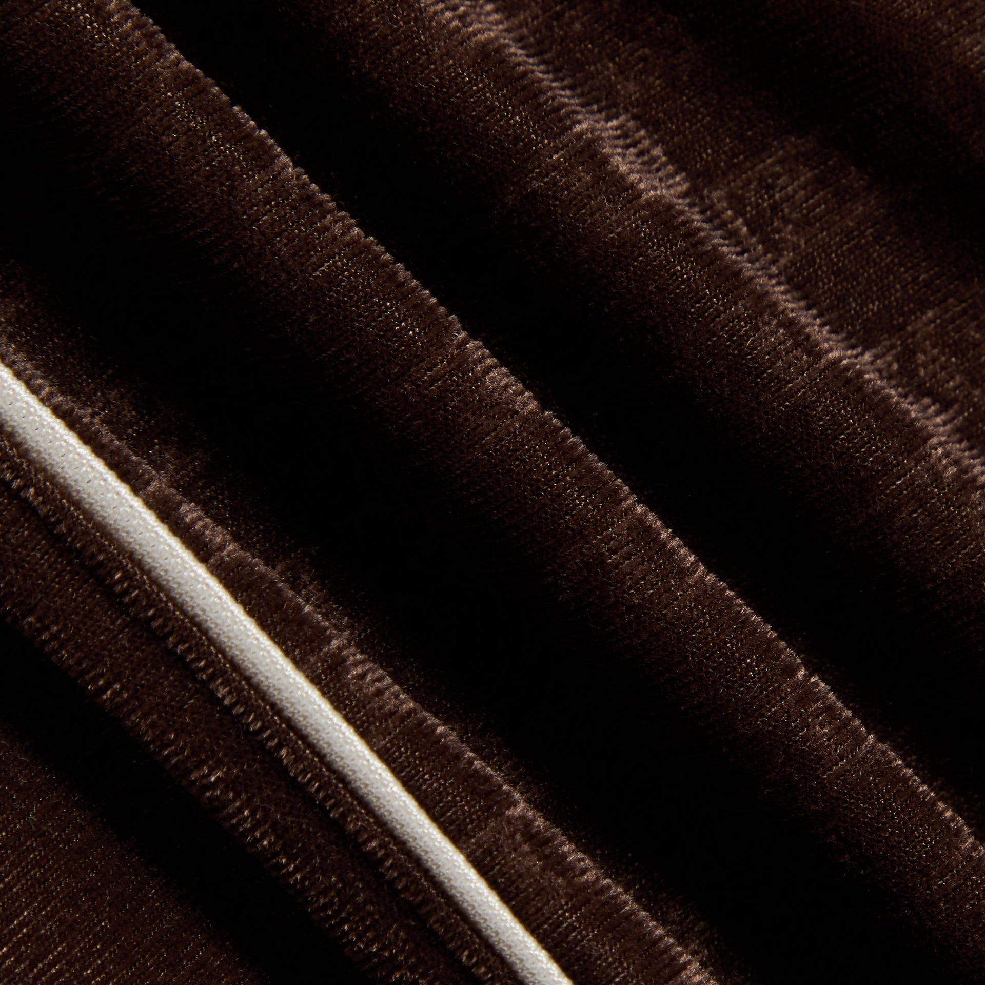 Kith Kids Monogram Velour Jordan Short in brown Kindling, close-up of velour fabric with cream piping