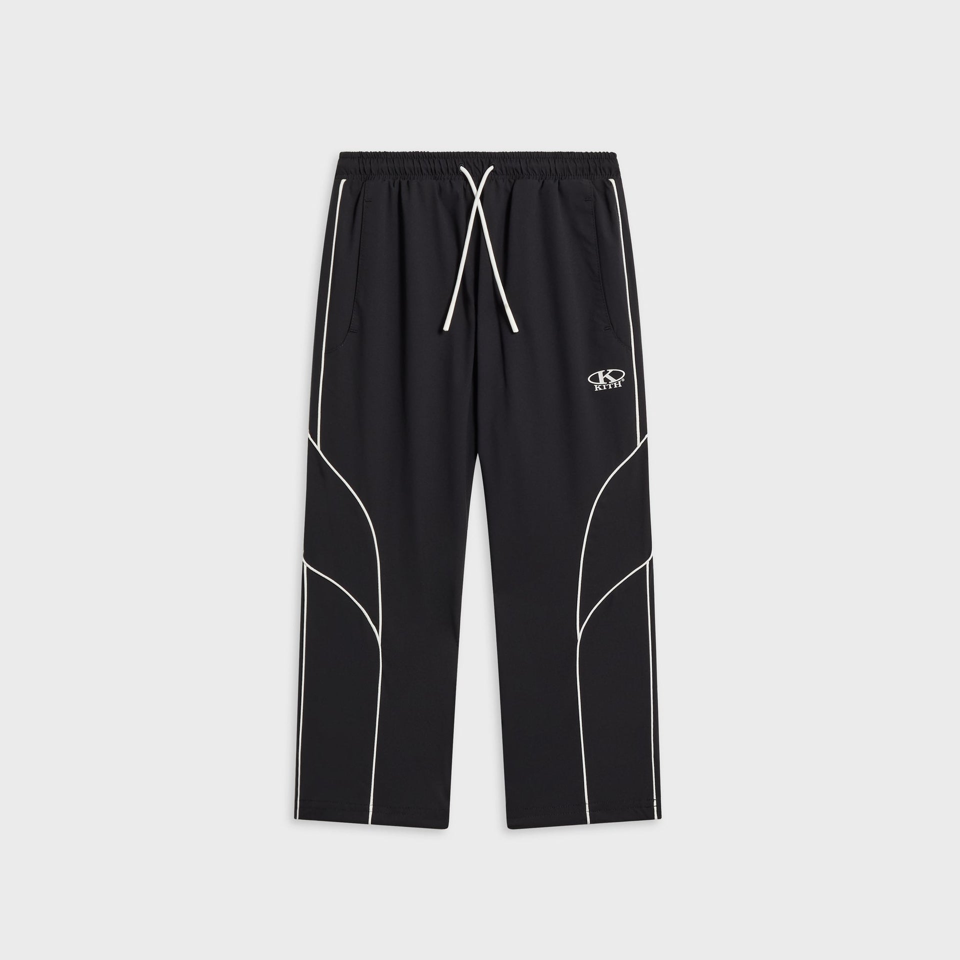 Kith Kids Novelty Dawson jogger in black with white piping, drawstring waist, and oval KITH logo at the hip