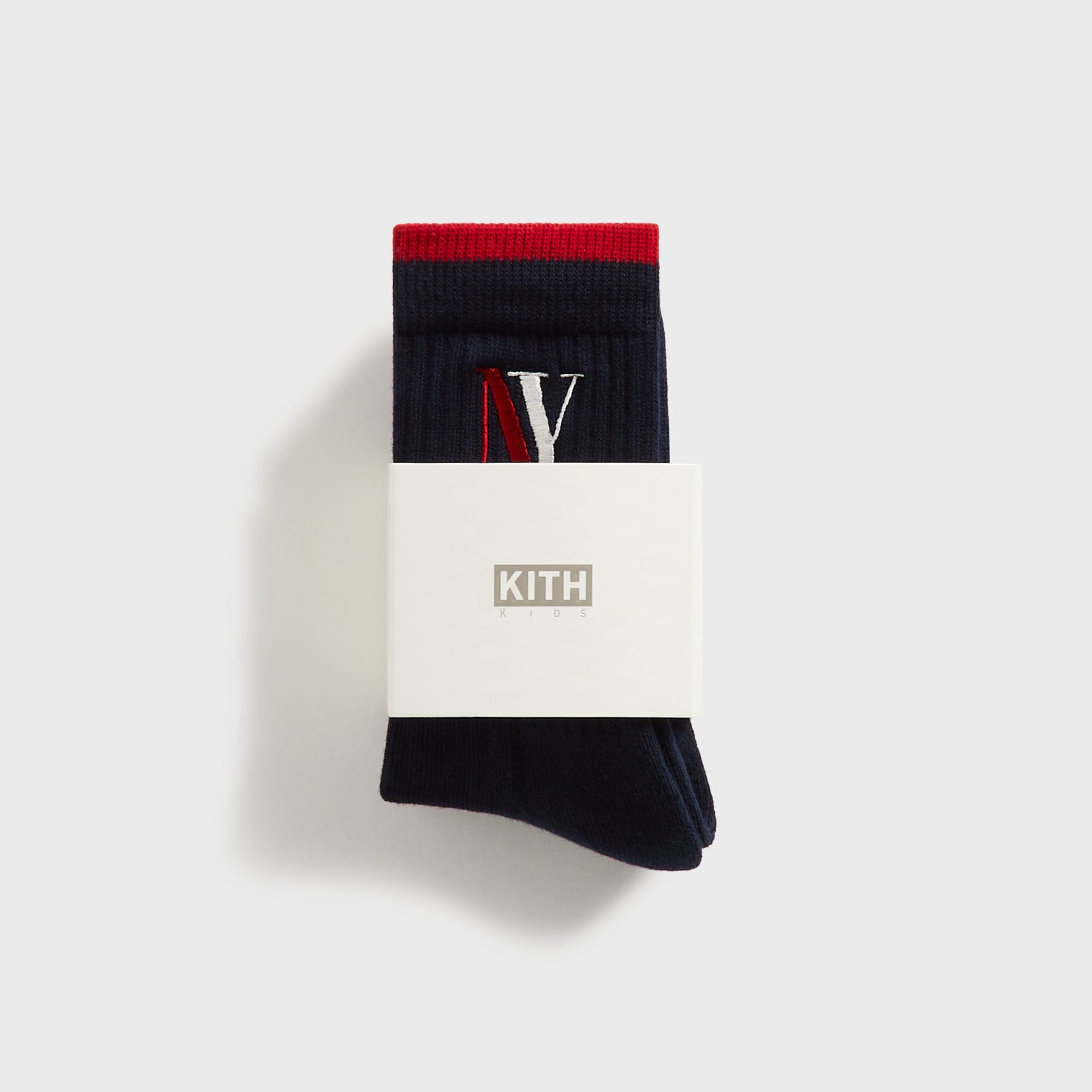 Kith Kids NY Socks, navy pair folded in Kith Kids branded packaging band