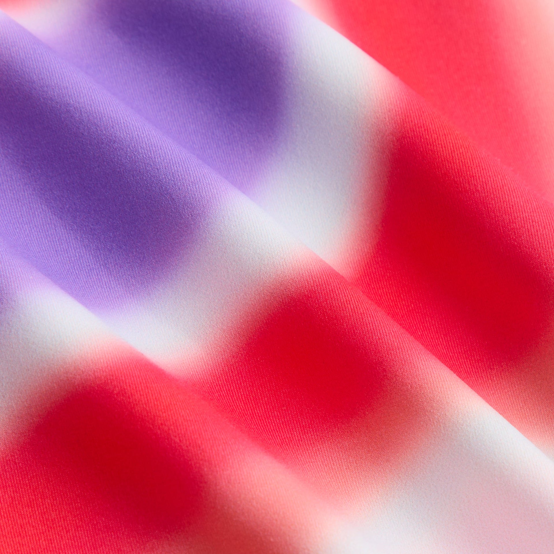 Kith Kids Remi Romper fabric close-up of Tempo swirl print in red, purple and white