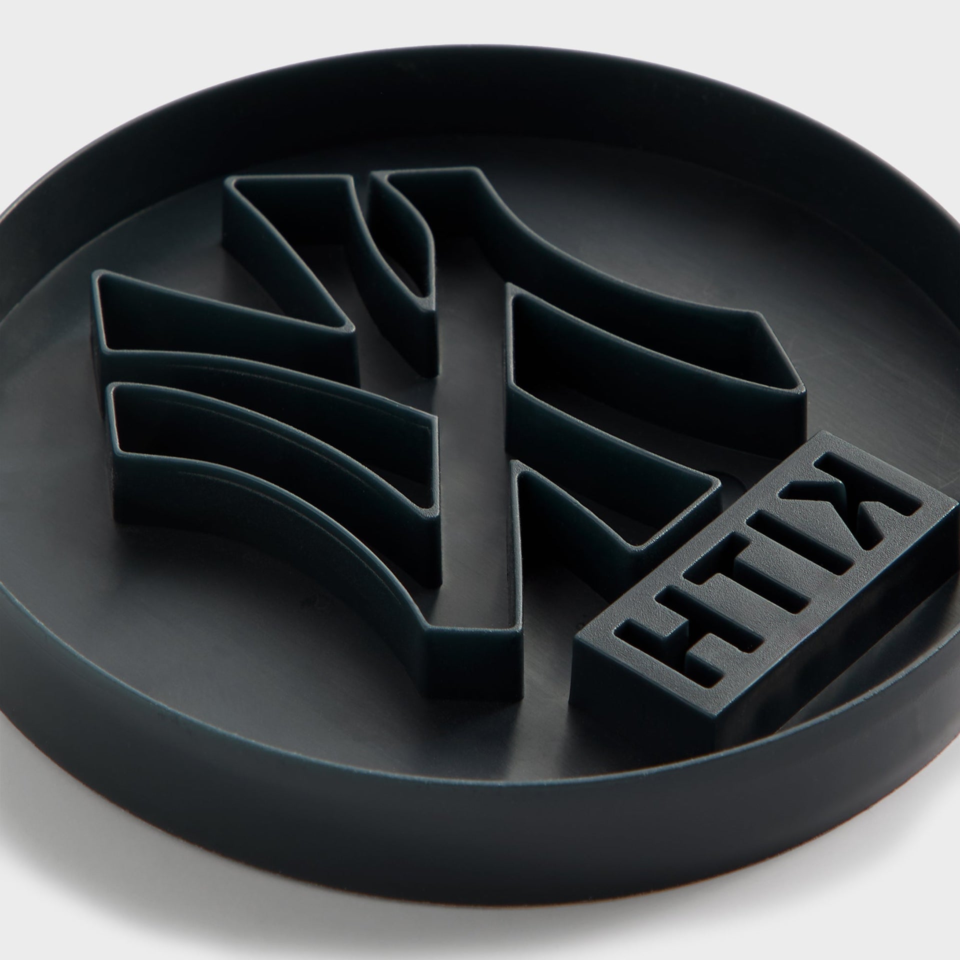 Angled close-up of the Kith x New York Yankees cookie cutter showing the NY logo blade edge