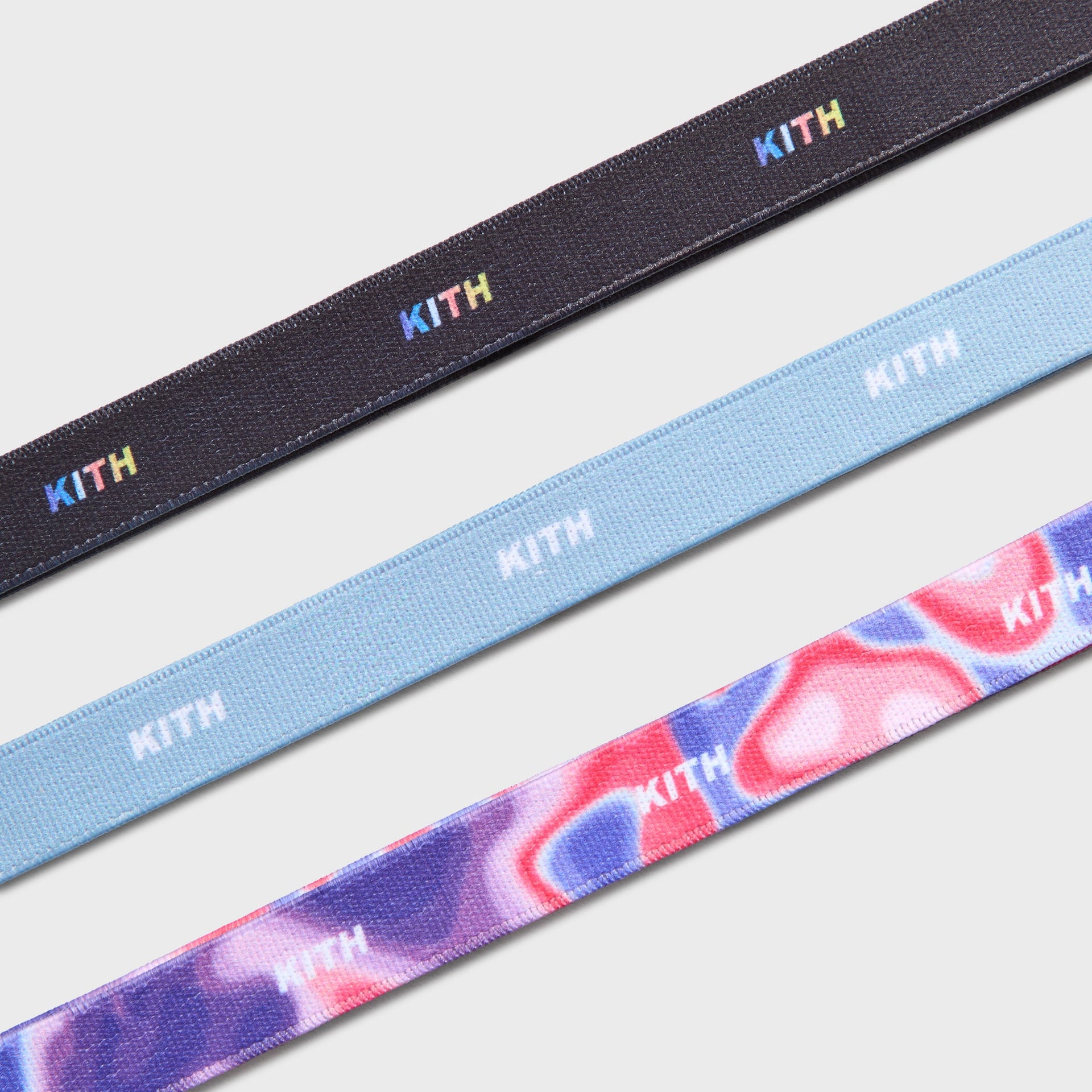 Kith Kids Printed Headbands close-up detail of black, light blue, and pink-purple swirl straps