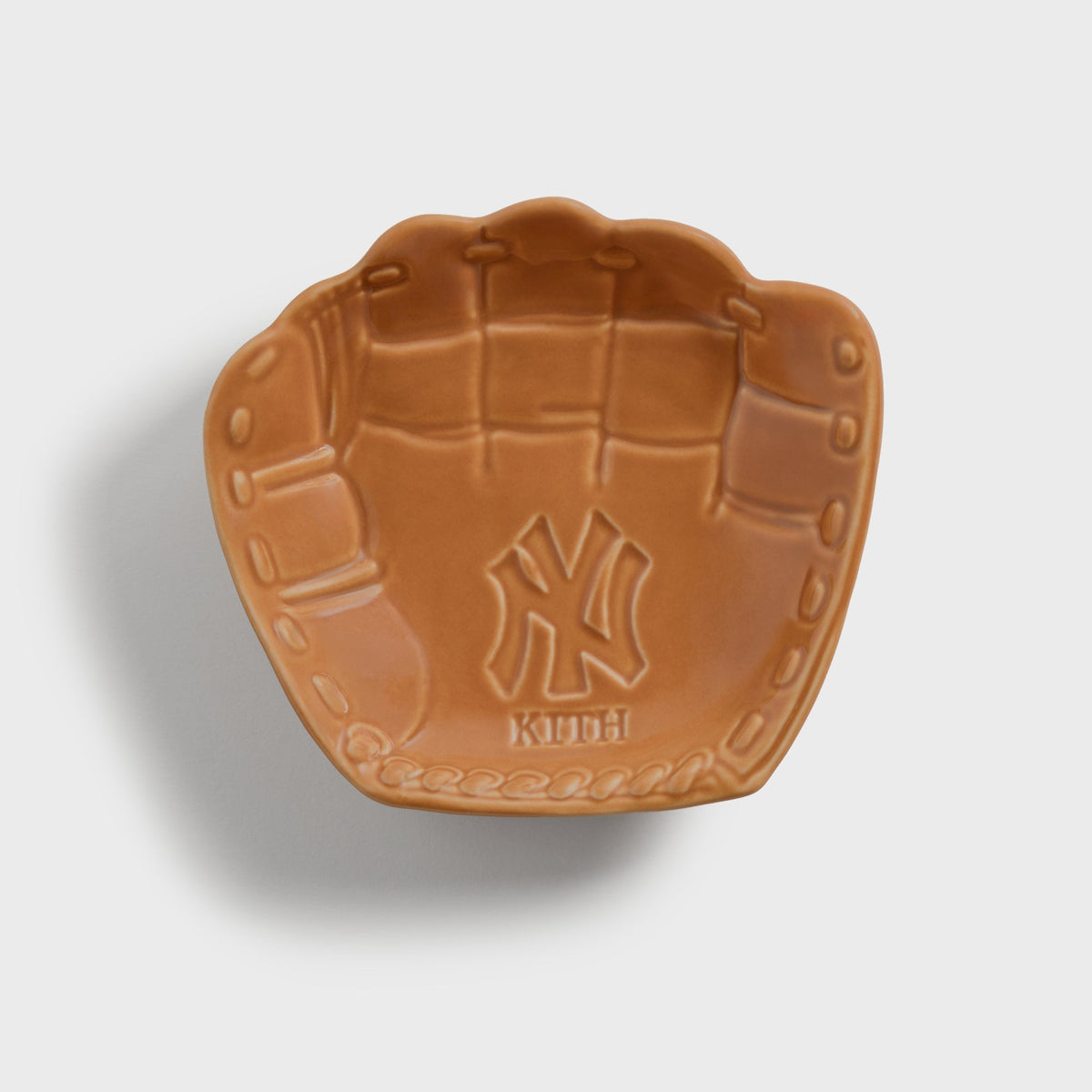 Kith x Yankees Baseball Glove Catchall Tray in tan - top-down view of glove-shaped ceramic dish with embossed NY logo